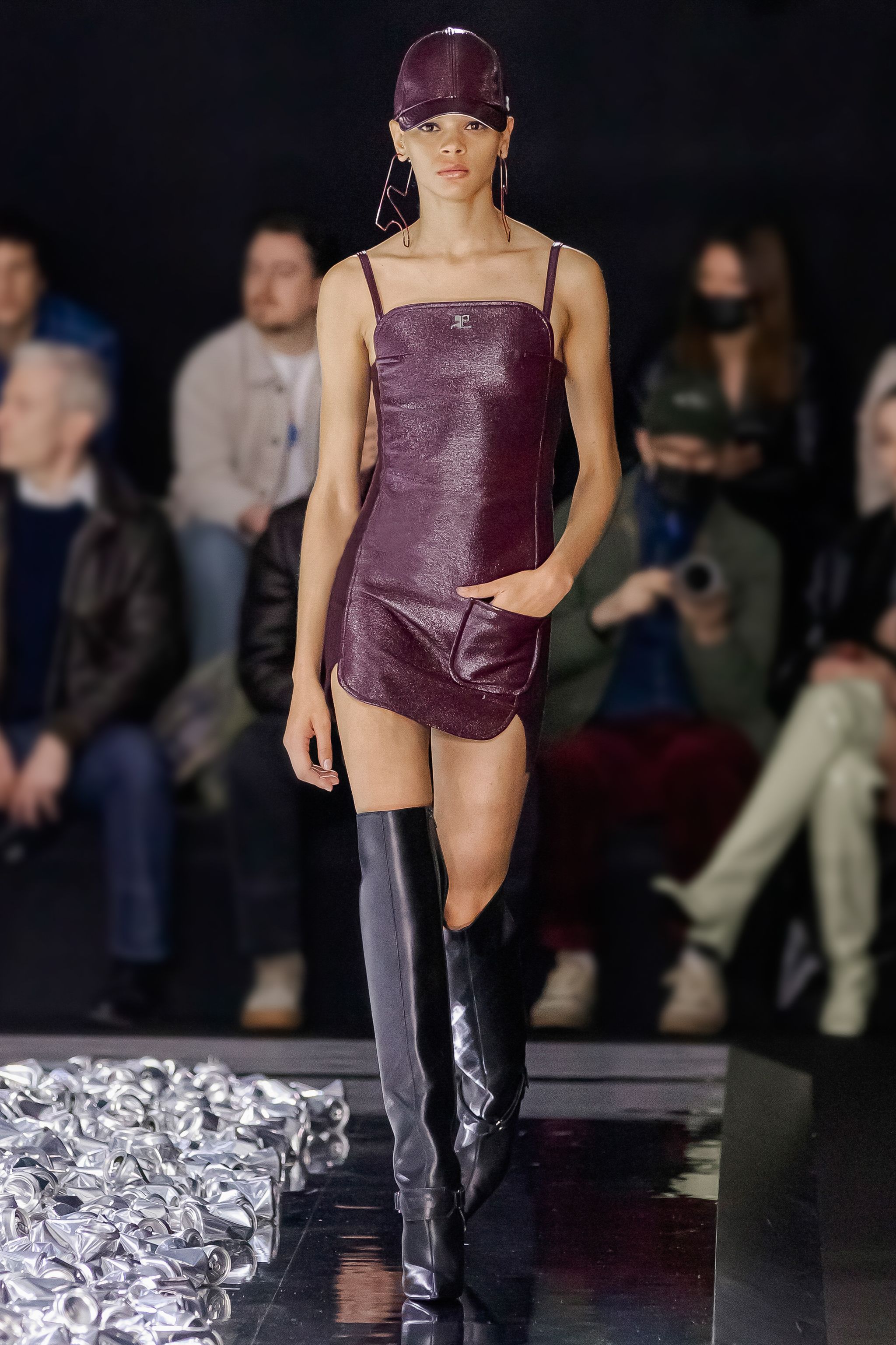 Elegant purple leather mini dress with thin straps, on a runway for Courrèges fashion brand.