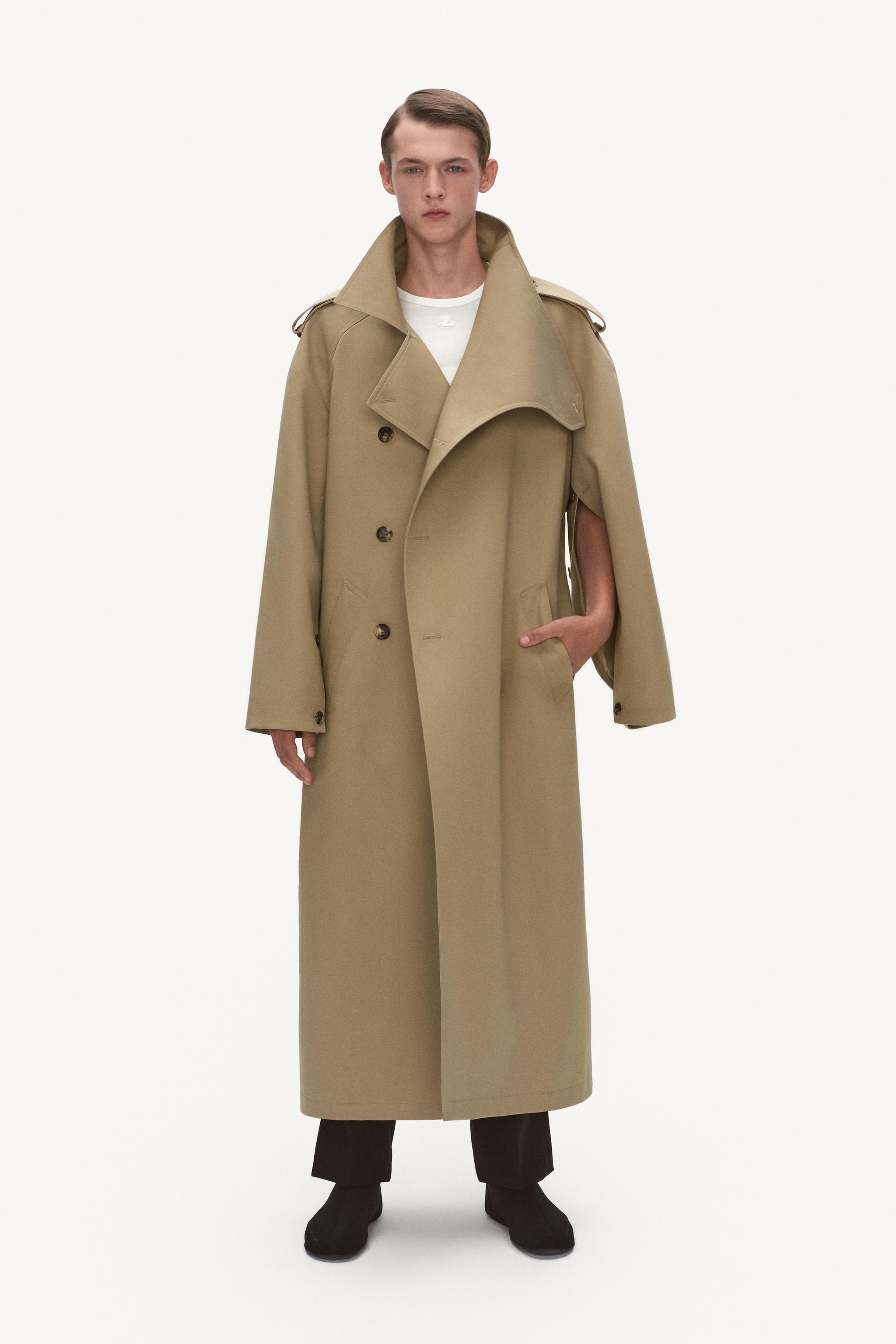 Elegant beige trench coat by Courrèges, featuring classic design for modern fashion lovers.