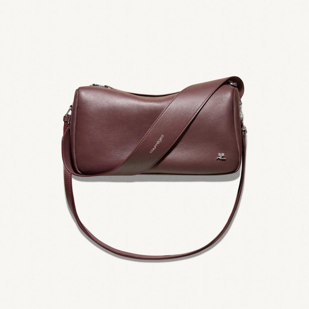 Elegant maroon leather Courrèges handbag with silver logo, perfect for fashion accessories.