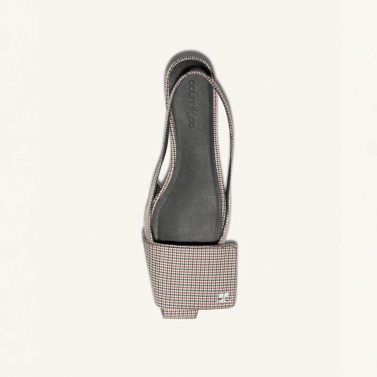 Elegant Courrèges flat sandal with striped fabric straps on a white background.