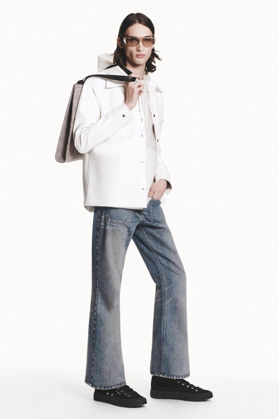 Elegant Courrèges female fashion featuring a white jacket, jeans, and accessories, perfect for e-commerce.