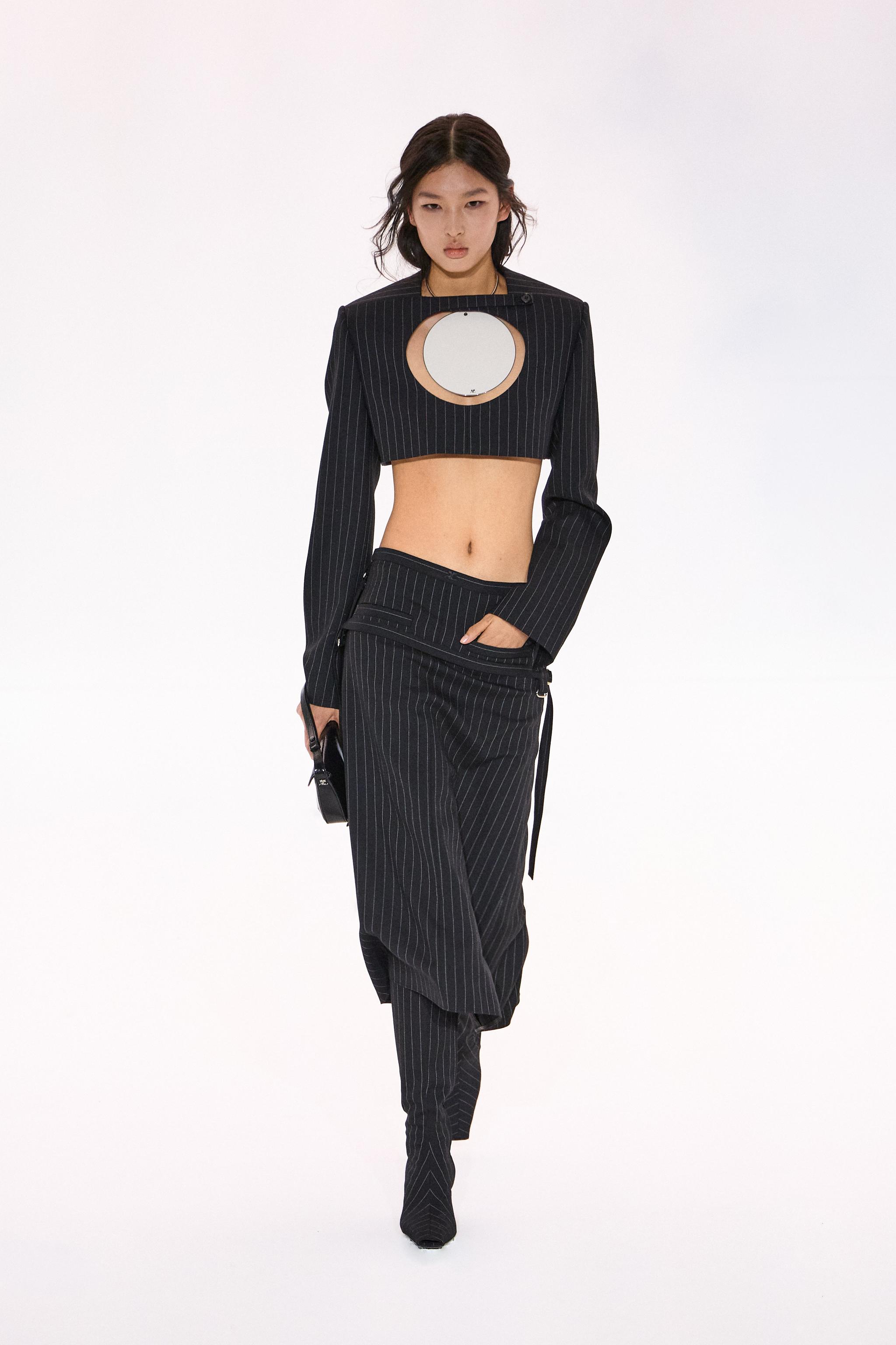 Elegant black pinstripe fashion look from Courrèges featuring a cropped blazer and matching trousers.