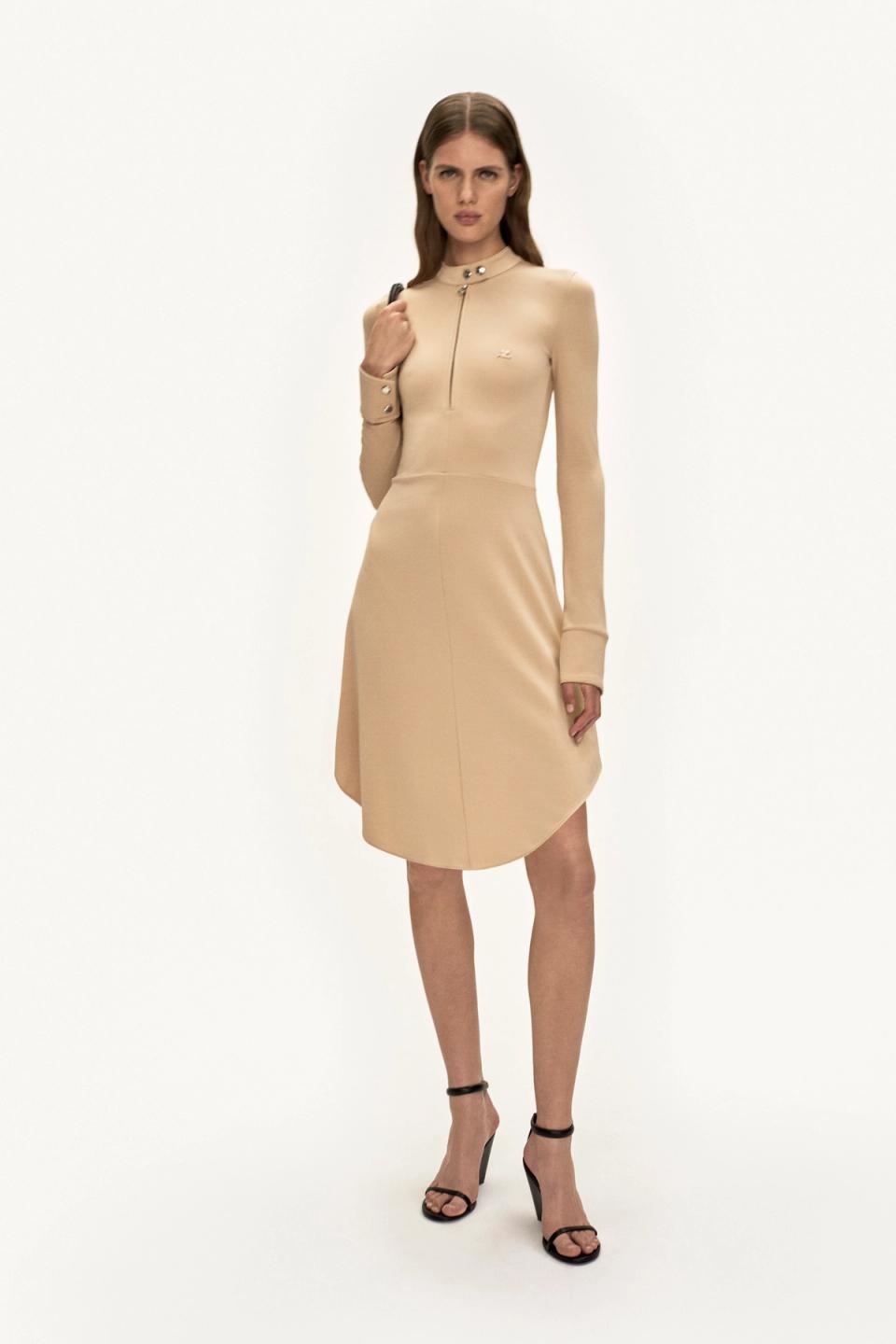 Elegant beige dress by Courrèges featuring a high collar, long sleeves, and modern silhouette.