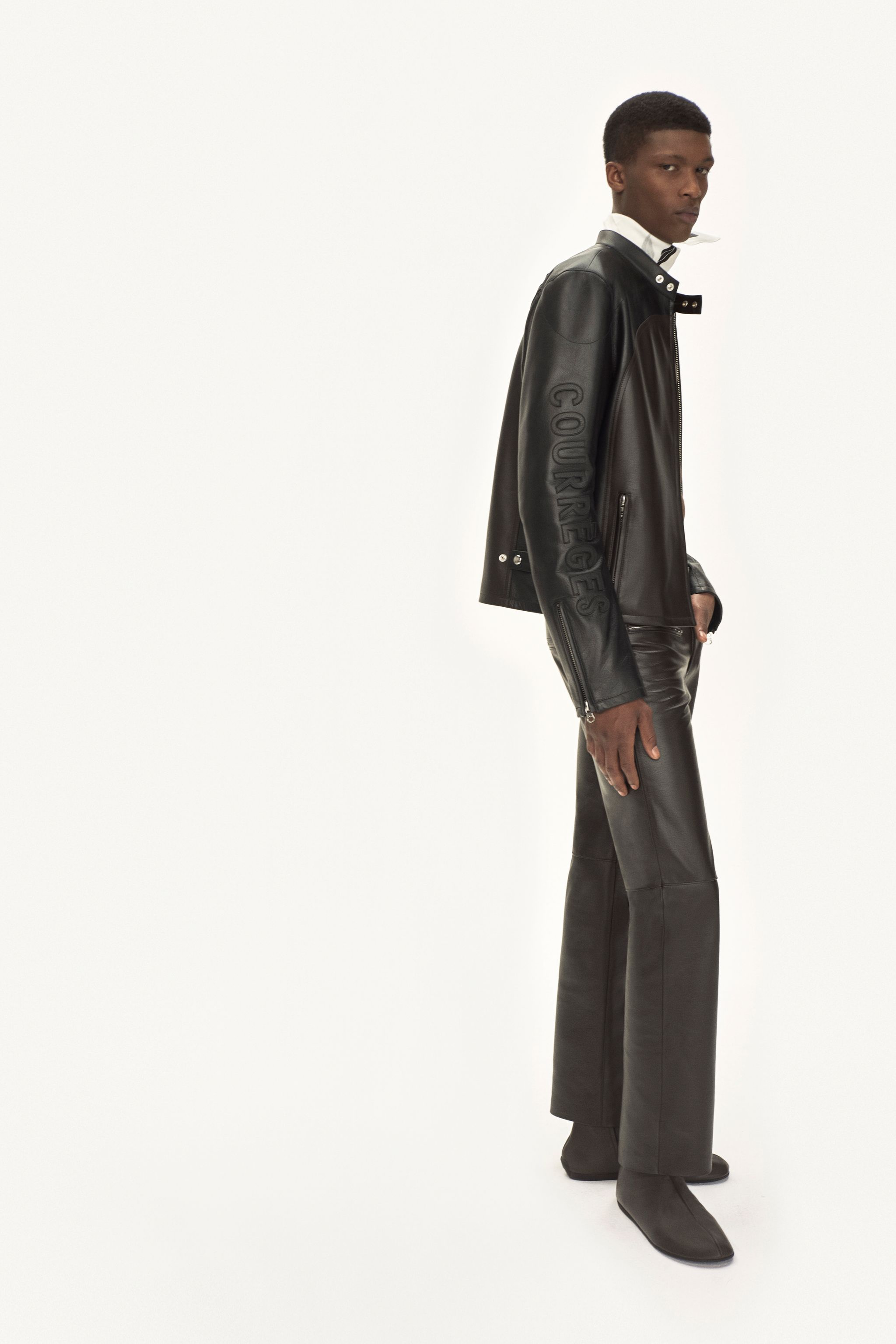 Elegant black leather jacket and pants featuring Courrèges branding for fashion-forward style.