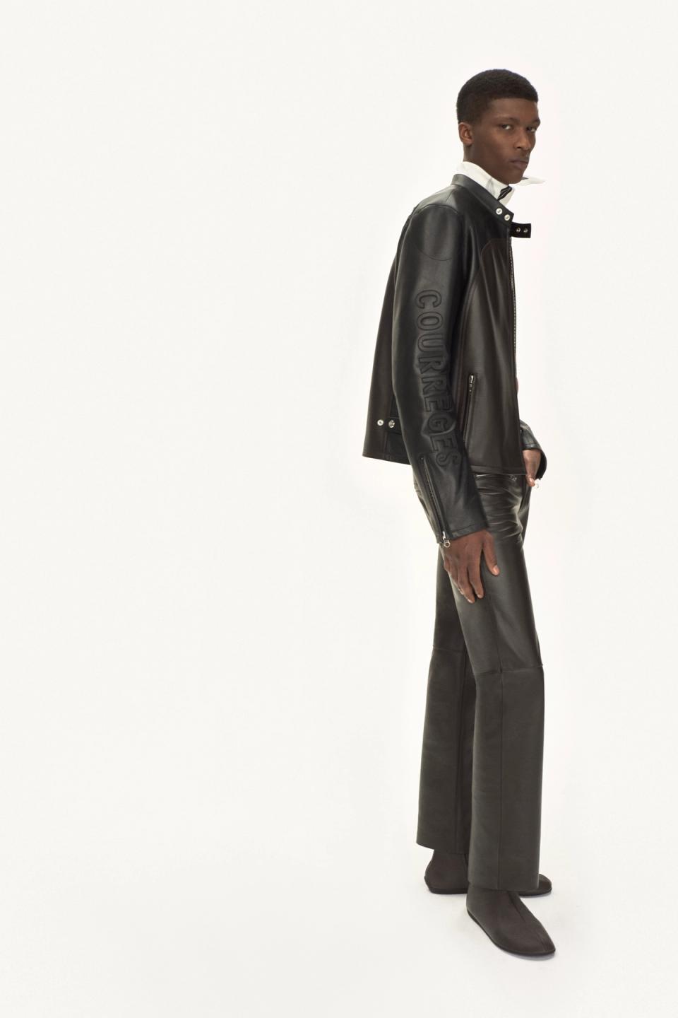 Elegant black leather jacket and pants featuring Courrèges branding for fashion-forward style.
