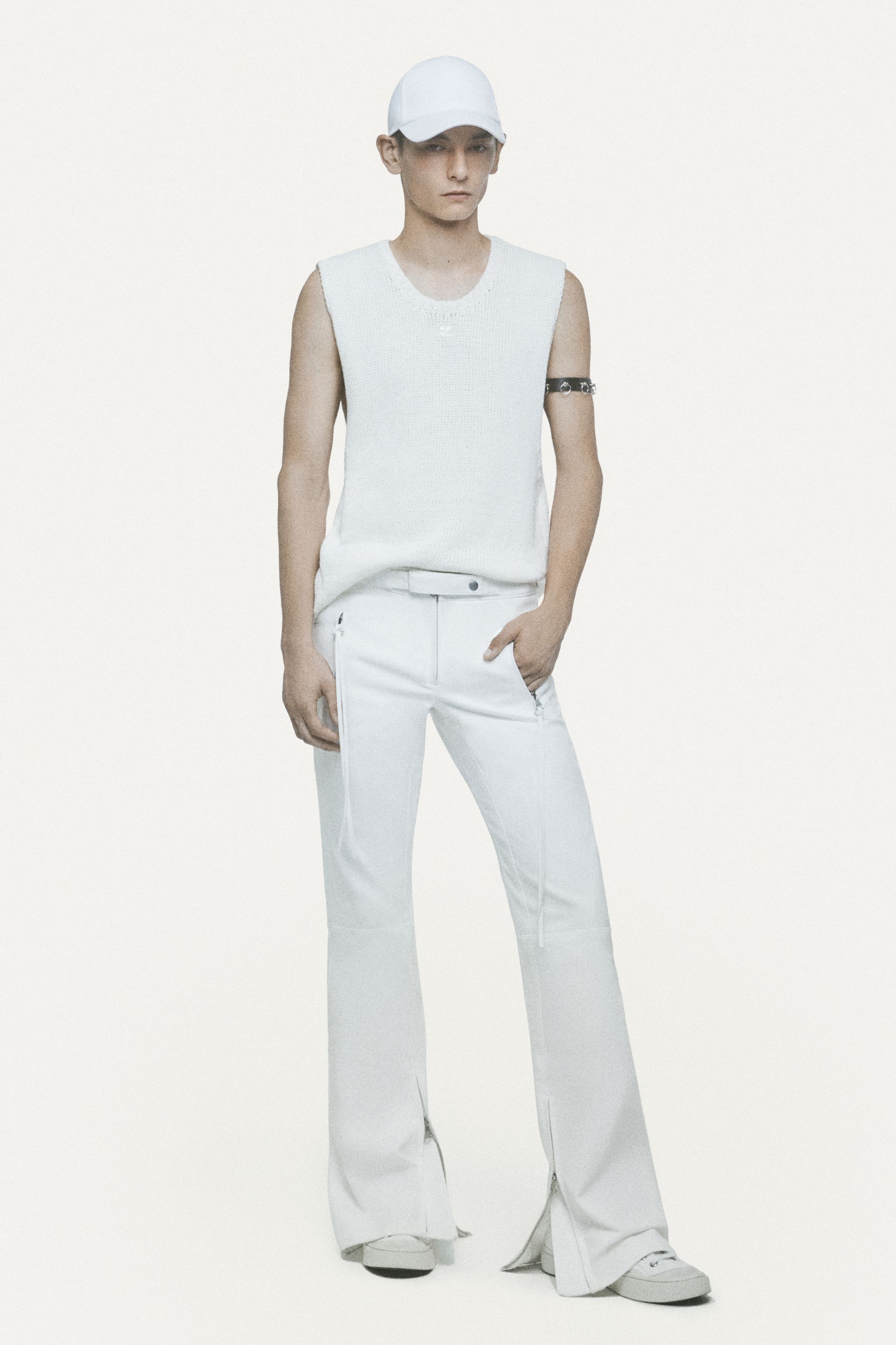 Model wearing all-white futuristic fashion look for Courrèges on an ecommerce site.