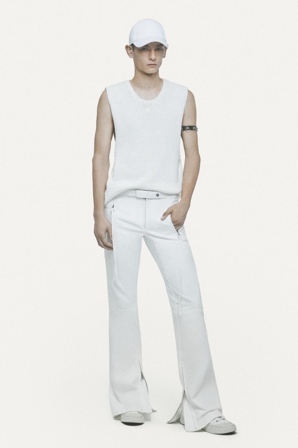 Model wearing all-white futuristic fashion look for Courrèges on an ecommerce site.