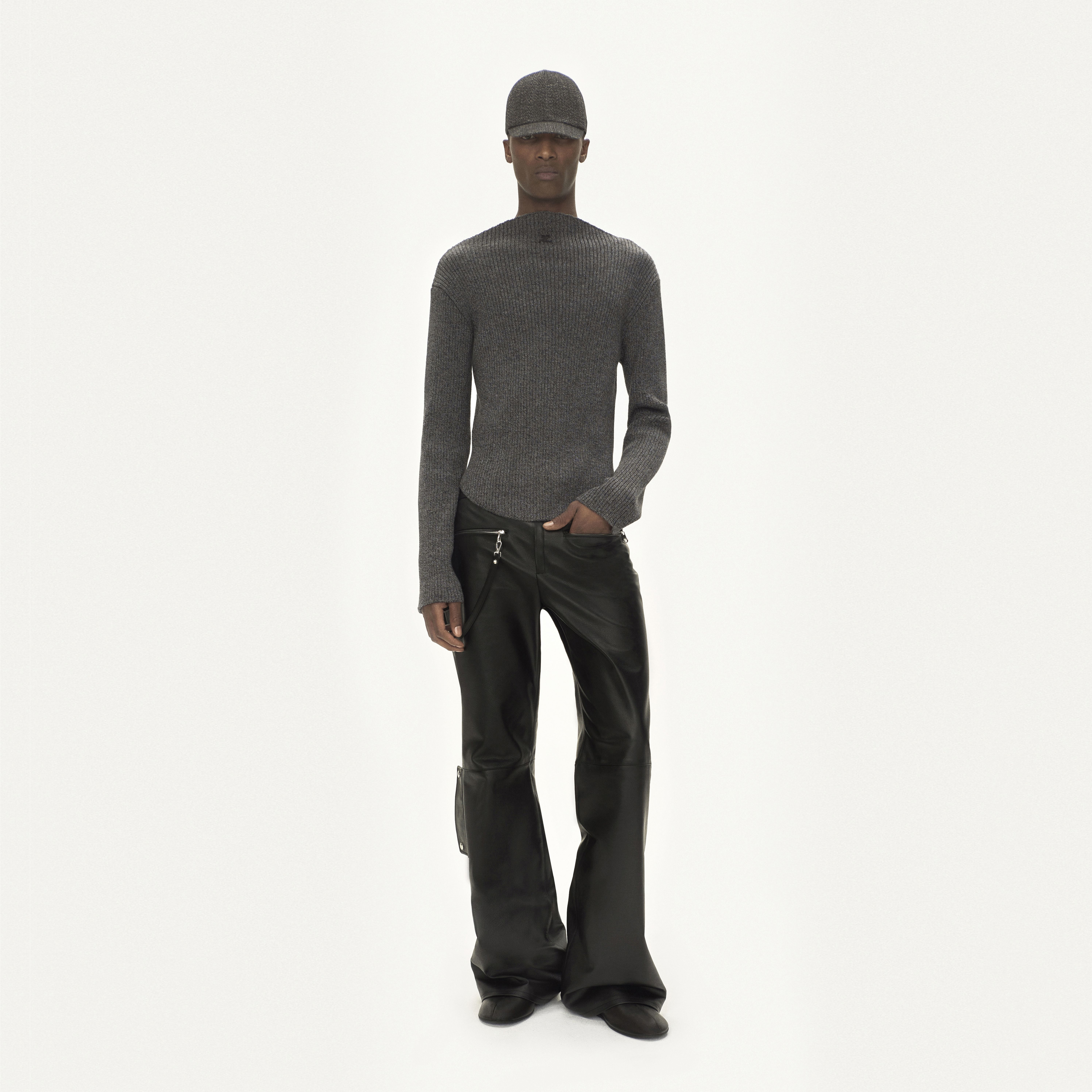 Elegant grey knit sweater and black leather pants showcase Courrèges modern fashion style.