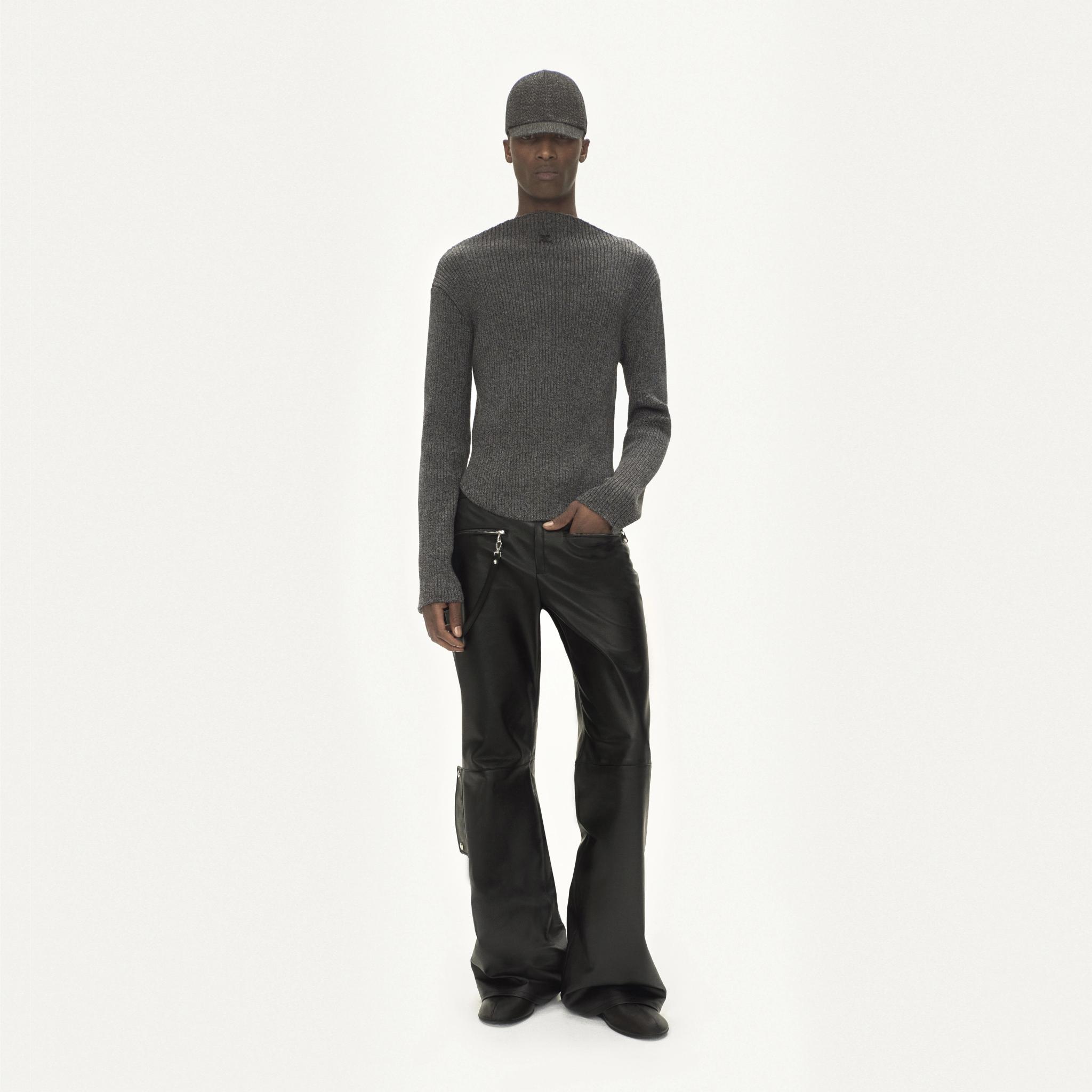 Elegant grey knit sweater and black leather pants showcase Courrèges modern fashion style.