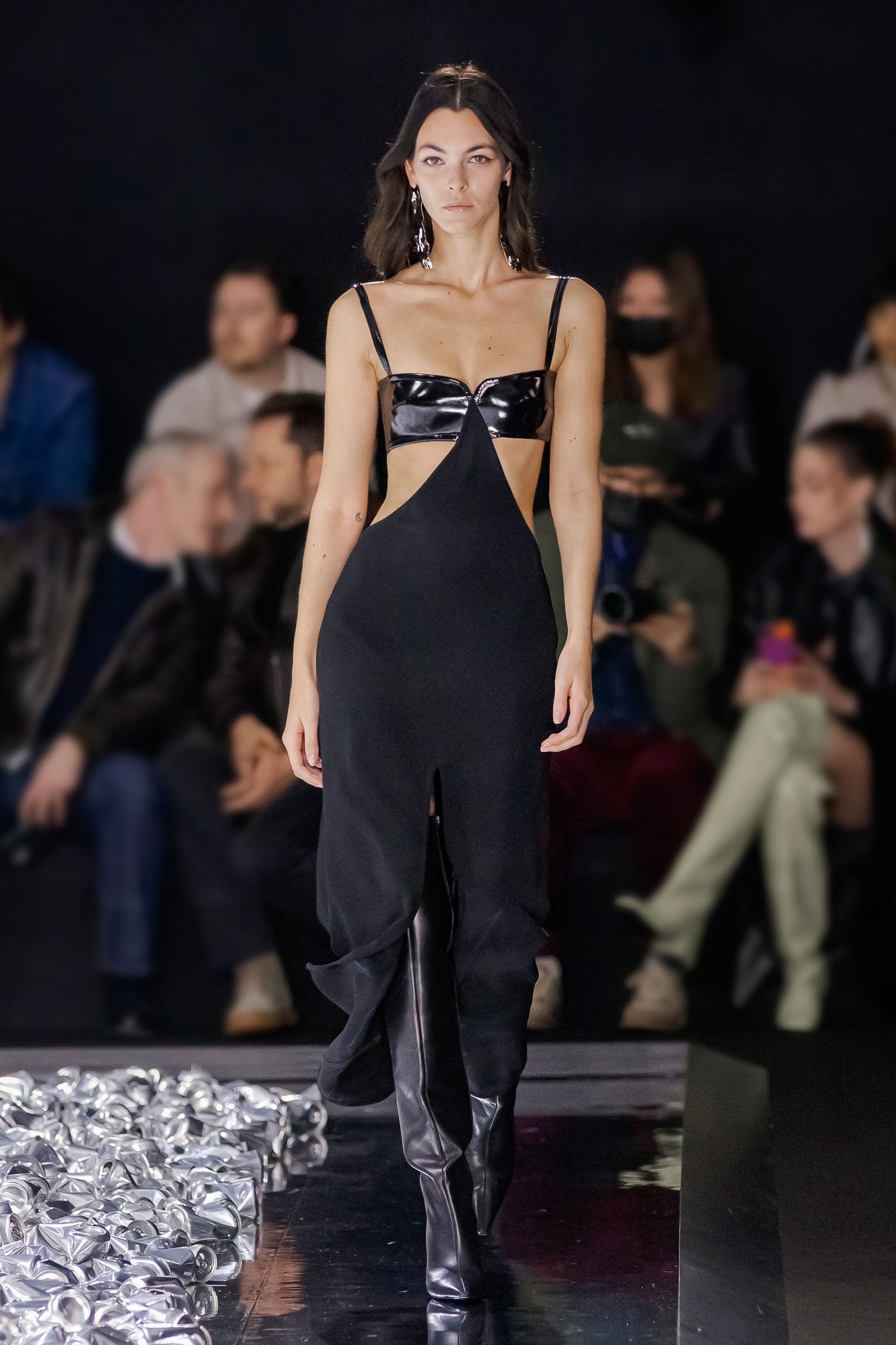 Elegant black cut-out dress from Courrèges showcased on a runway for fashion lovers.