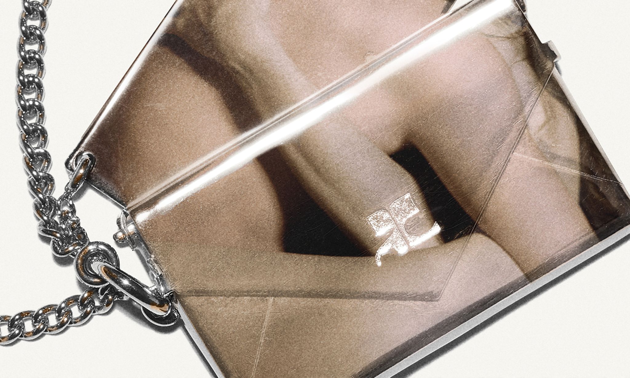 Elegant metallic clutch with chain strap, ideal for Courrèges fashion accessories and evening style.