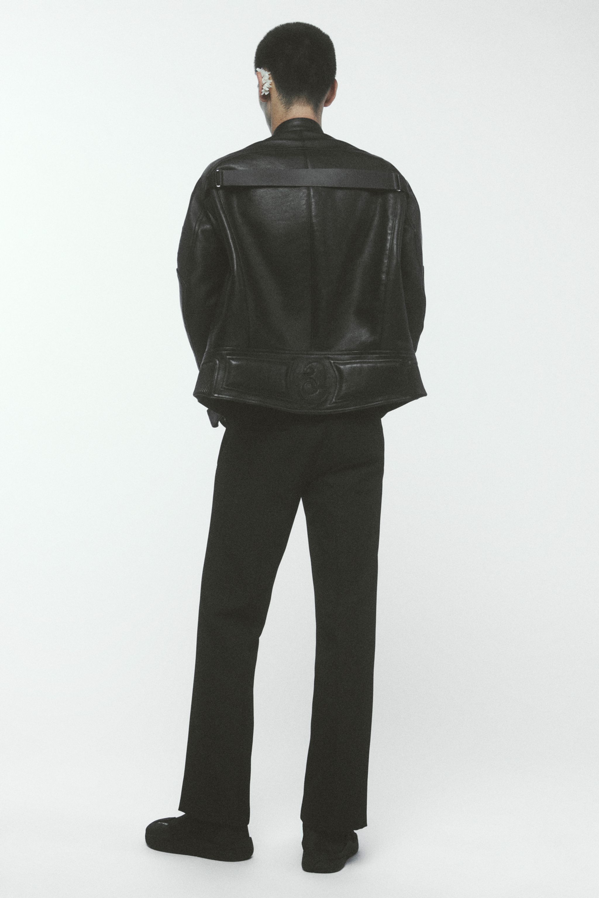 Elegant black leather jacket from Courrèges, showcasing contemporary minimalist style.