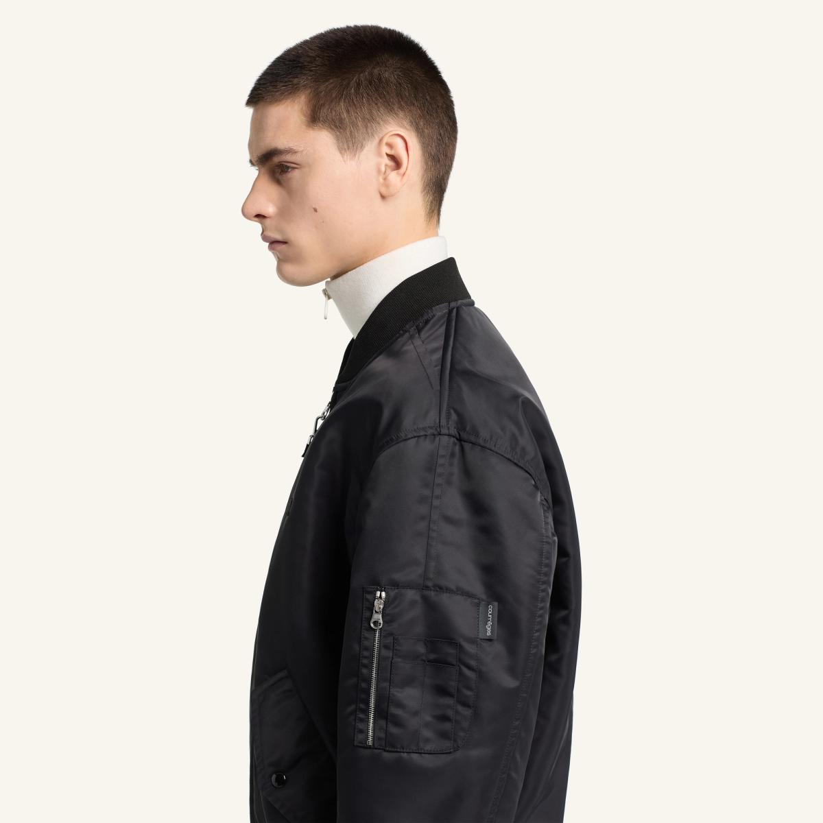 Elegant black Courrèges bomber jacket with modern details, ideal for fashion-forward style.