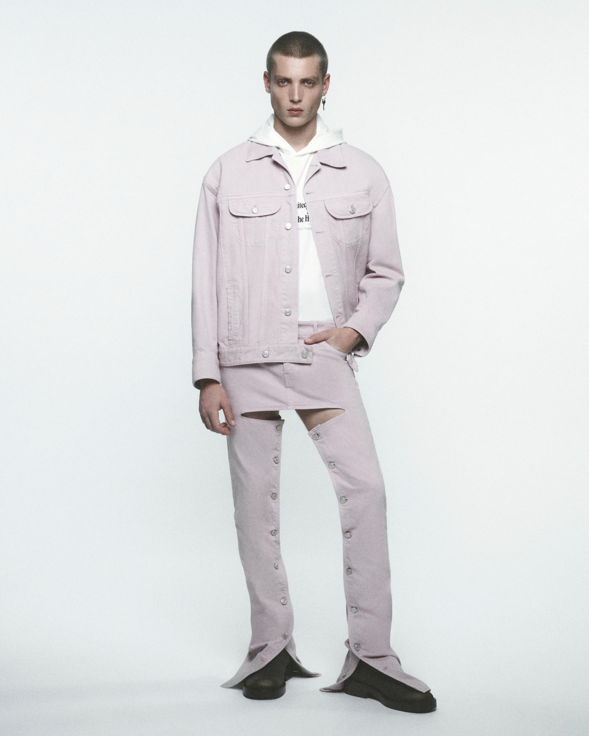 Elegant, trendy model wearing Courrèges pastel pink denim jacket and ripped jeans for fashion.