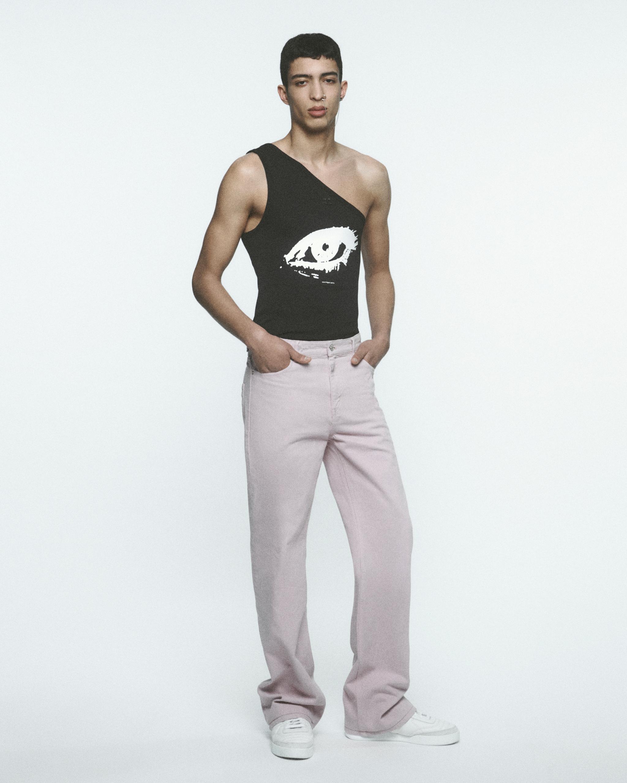 Elegant vintage-inspired black sleeveless top with white eye graphic, styled for Courrèges.