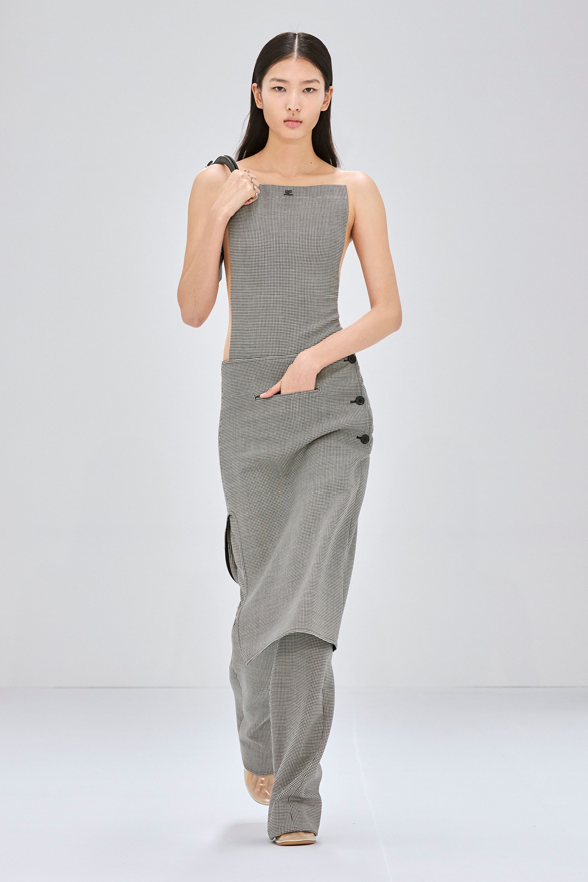 Elegant model wearing Courrèges checkered top and pants for a modern fashion statement.