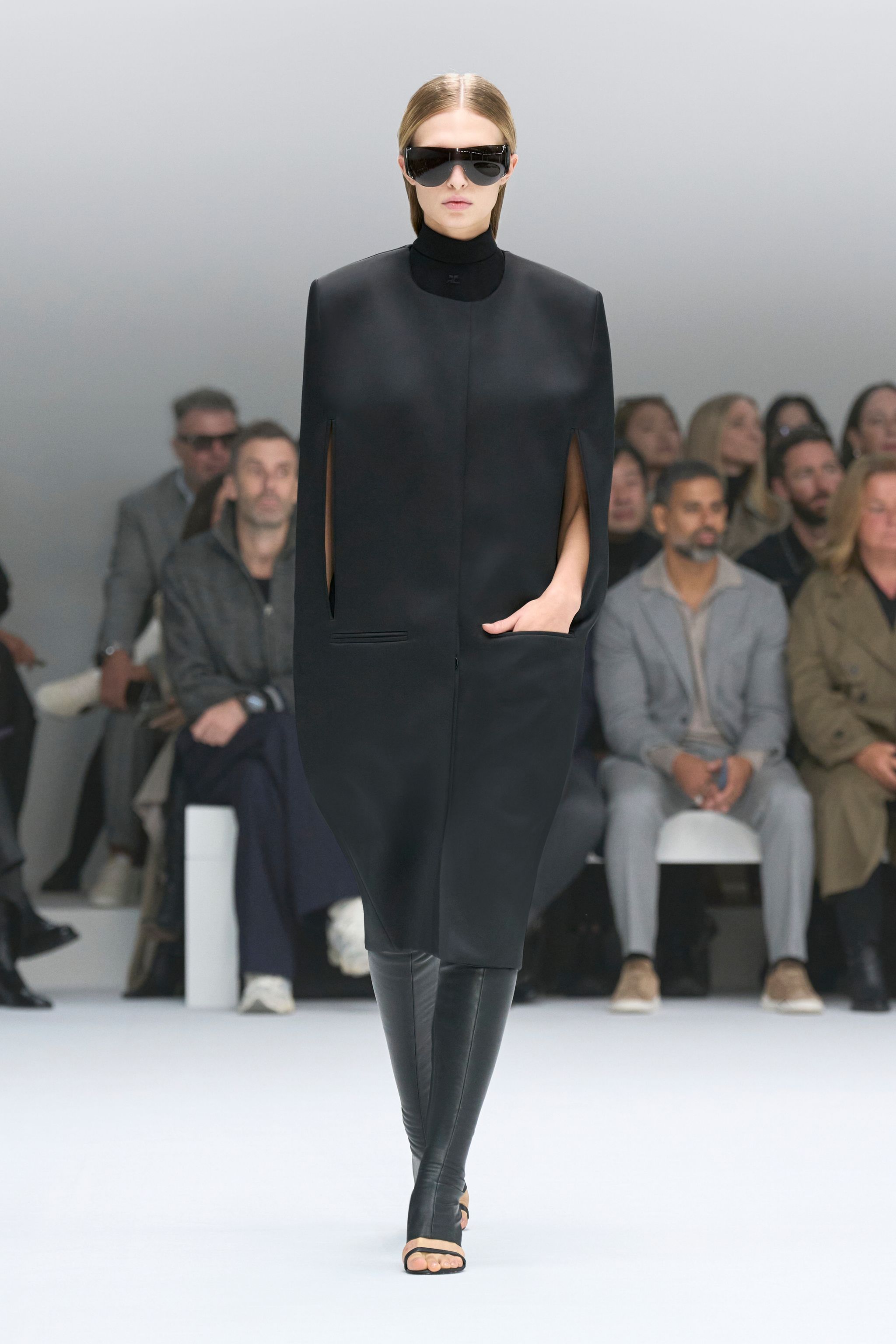 Elegant black fashion dress by Courrèges showcased on runway for an ecommerce site.