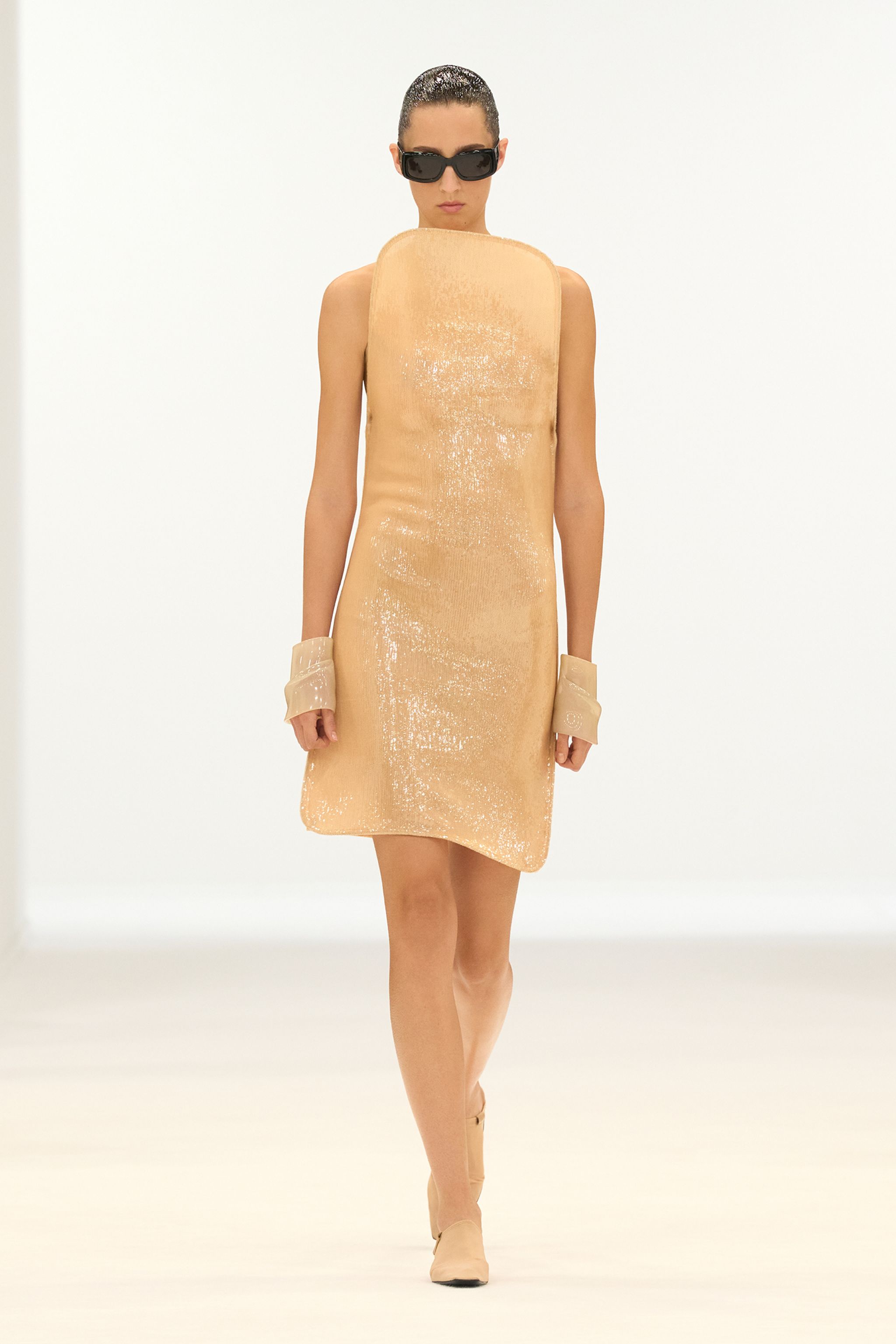 Elegant beige sequined sleeveless dress by Courrèges, perfect for fashion-forward looks.