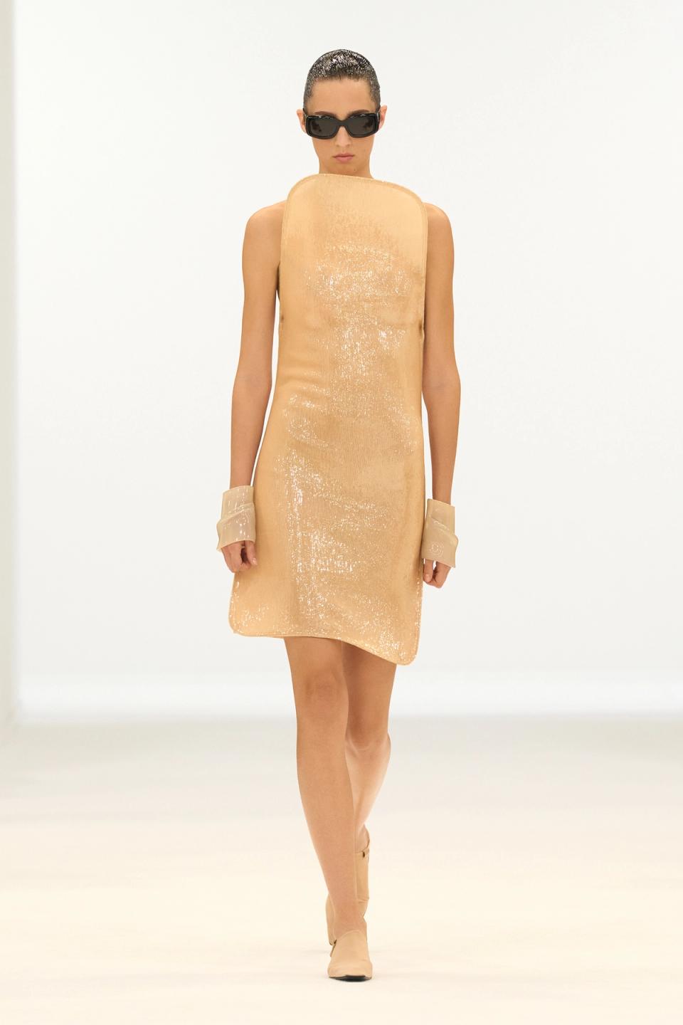 Elegant beige sequined sleeveless dress by Courrèges, perfect for fashion-forward looks.