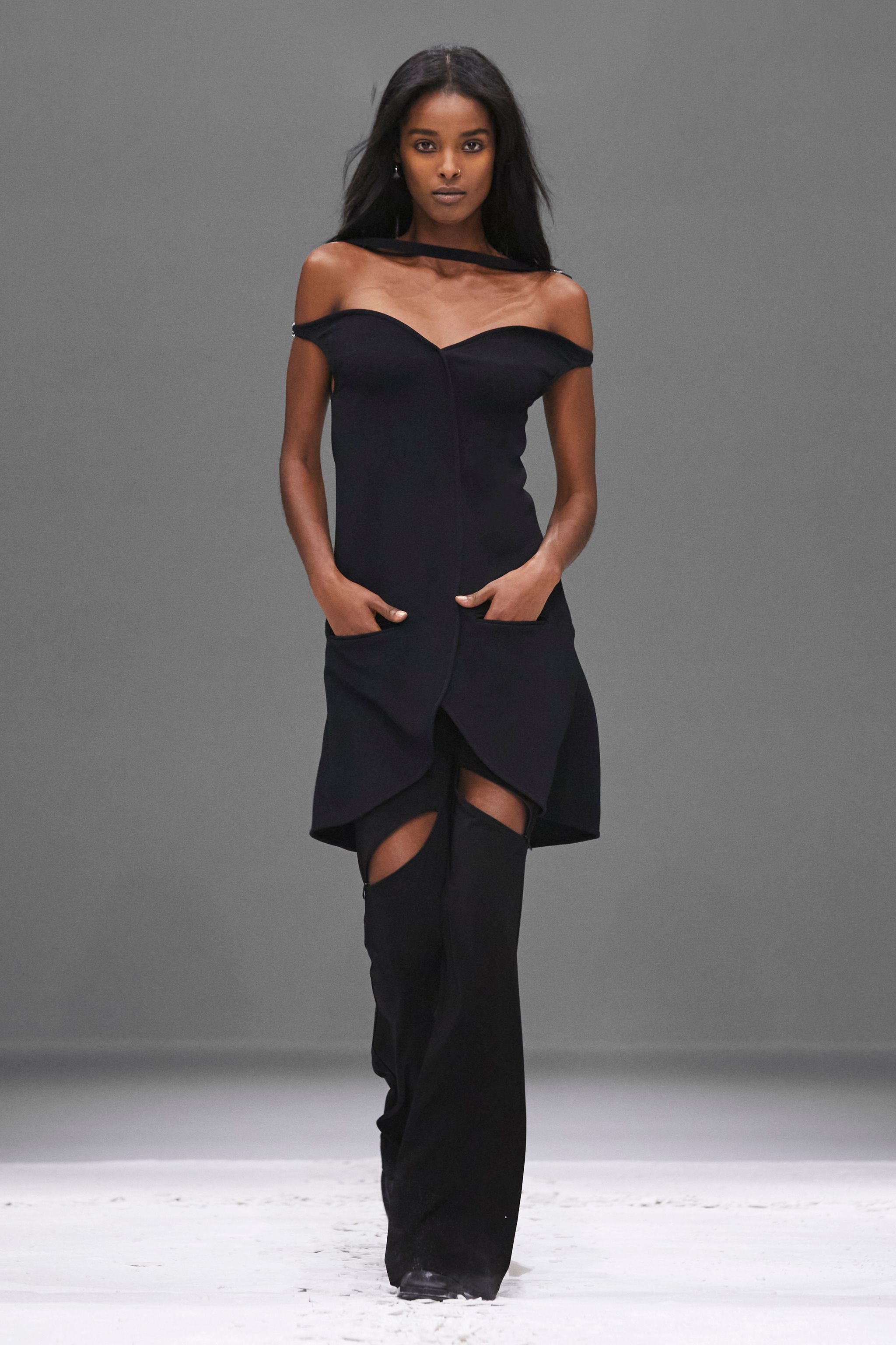 Elegant black off-shoulder dress with sheer neckline, from Courrèges fashion collection.