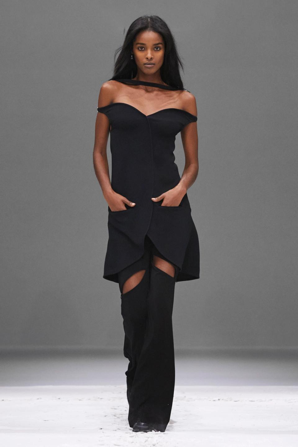 Elegant black off-shoulder dress with sheer neckline, from Courrèges fashion collection.