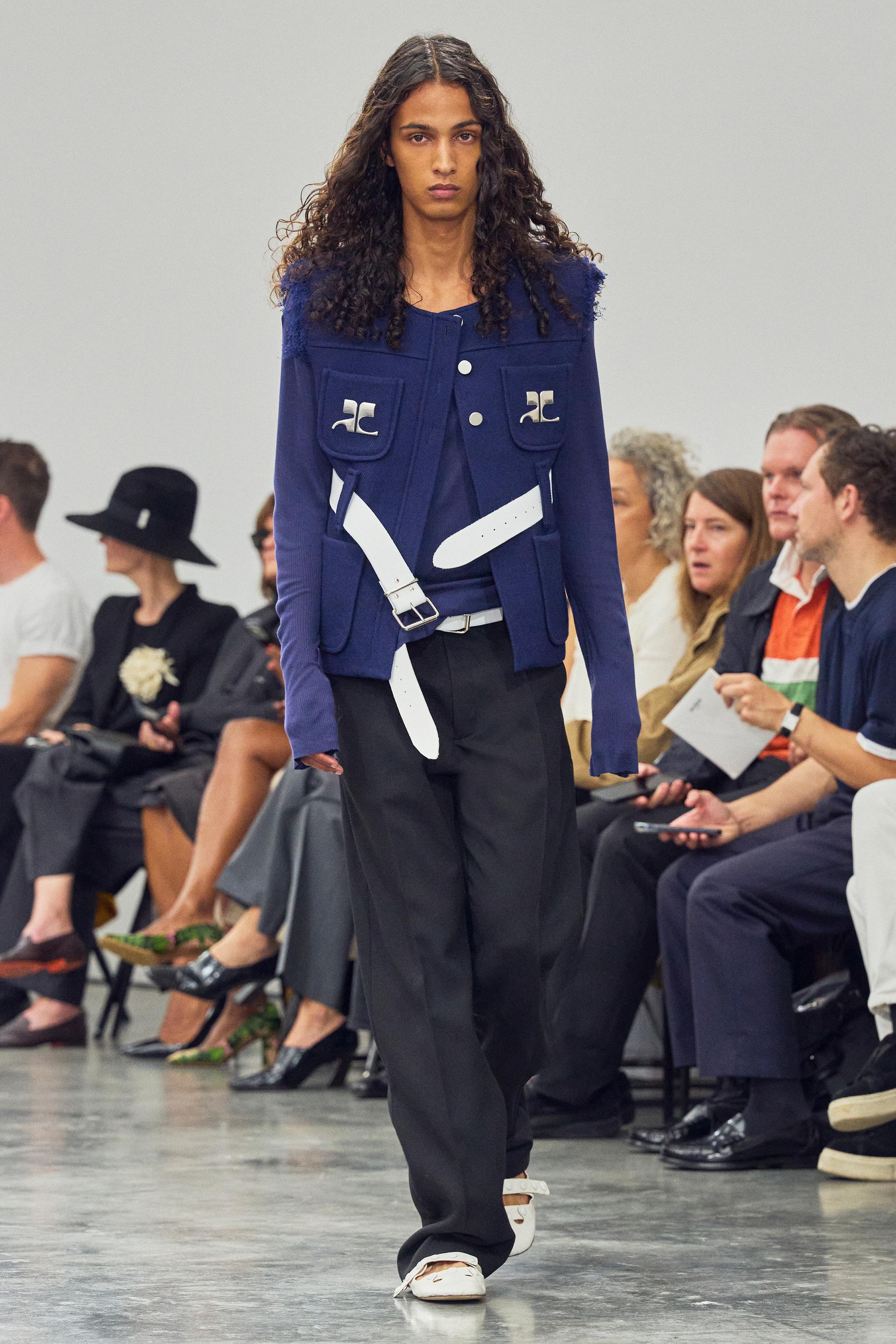 Elegant blue fashion jacket with patch pockets, showcased on runway for Courrèges collection.