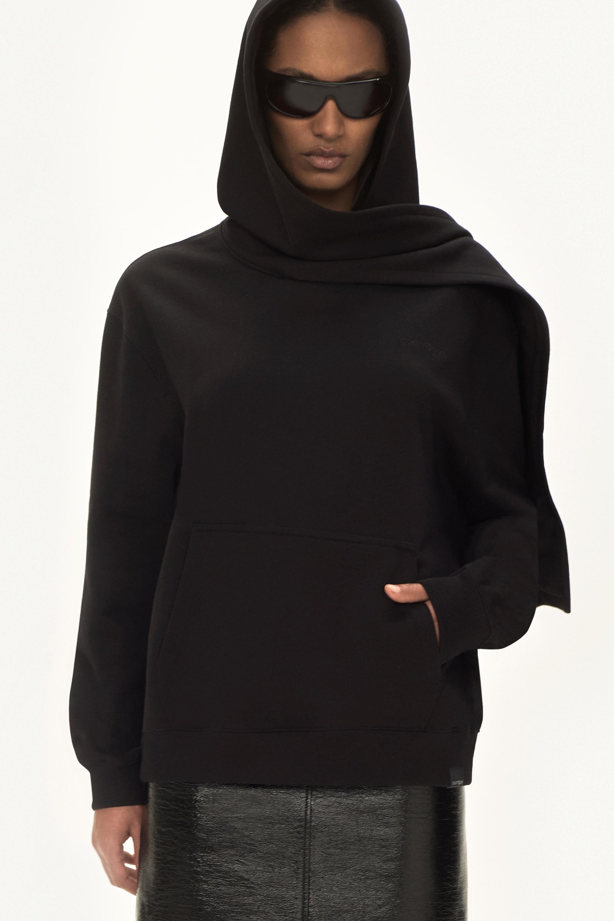 Sweat à capuche noir élégant, coupe oversized, design tendance pour la mode Courrèges.