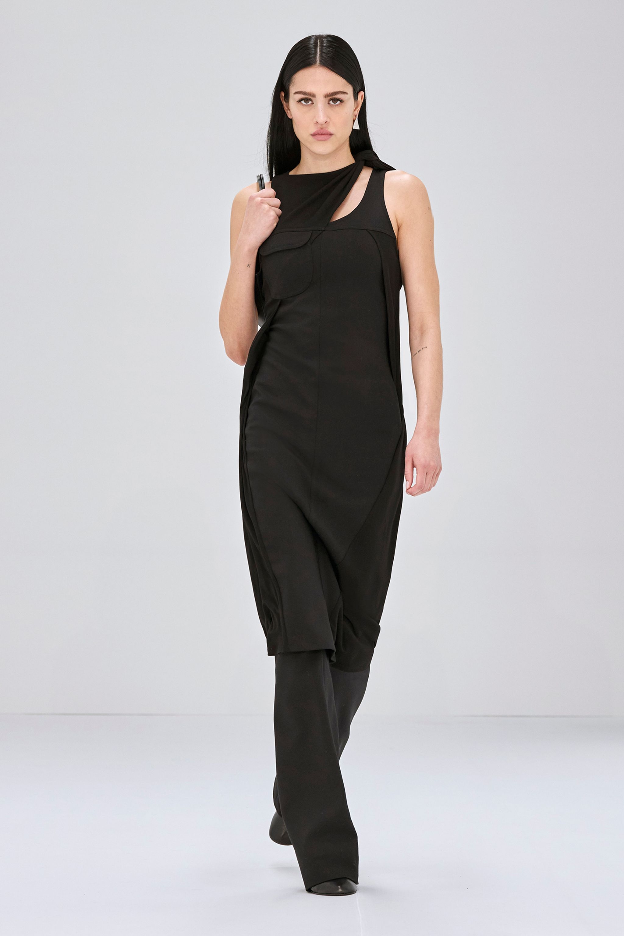 Elegant black faux fur coat from Courrèges, showcasing high fashion on the runway.
