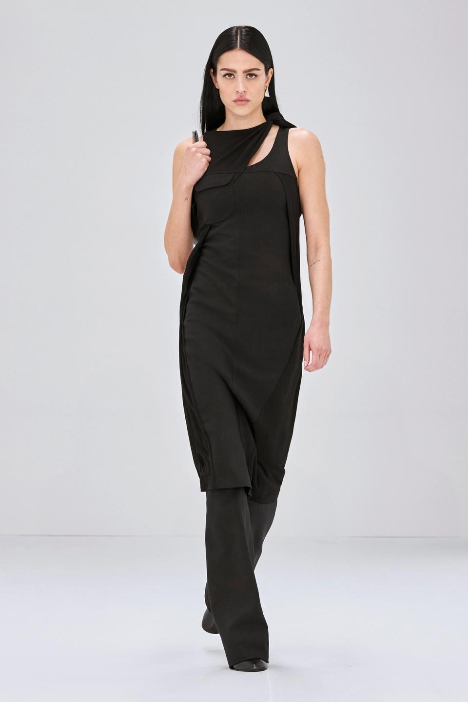 Elegant black faux fur coat from Courrèges, showcasing high fashion on the runway.