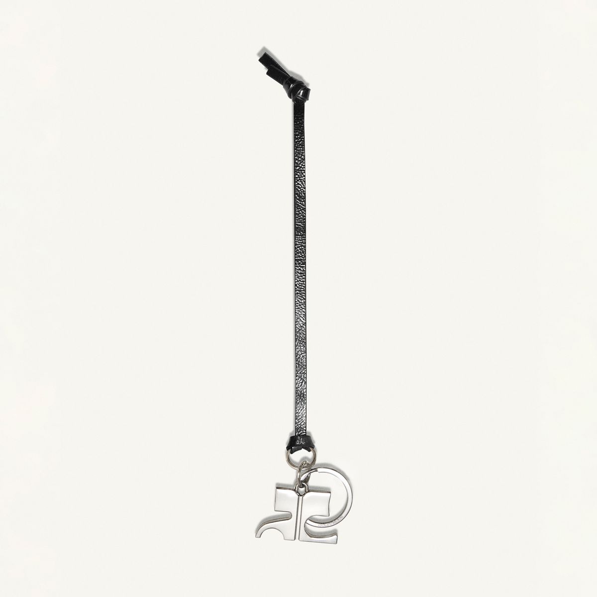 Elegant black lanyard with silver 'R2' charm, designed for Courrèges fashion brand showcases.