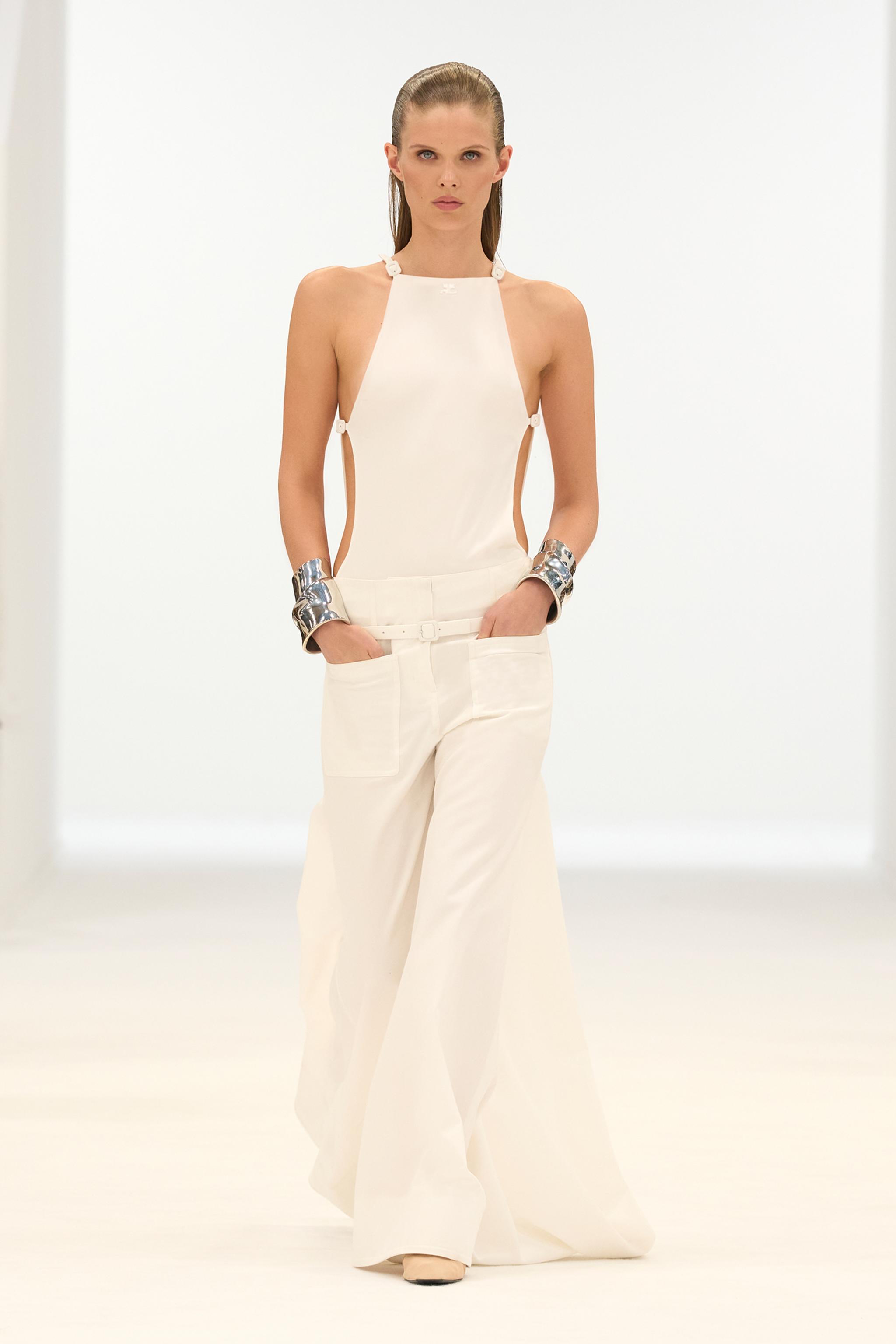Elegant white fashion ensemble showcased by Courrèges on a model for an e-commerce site.
