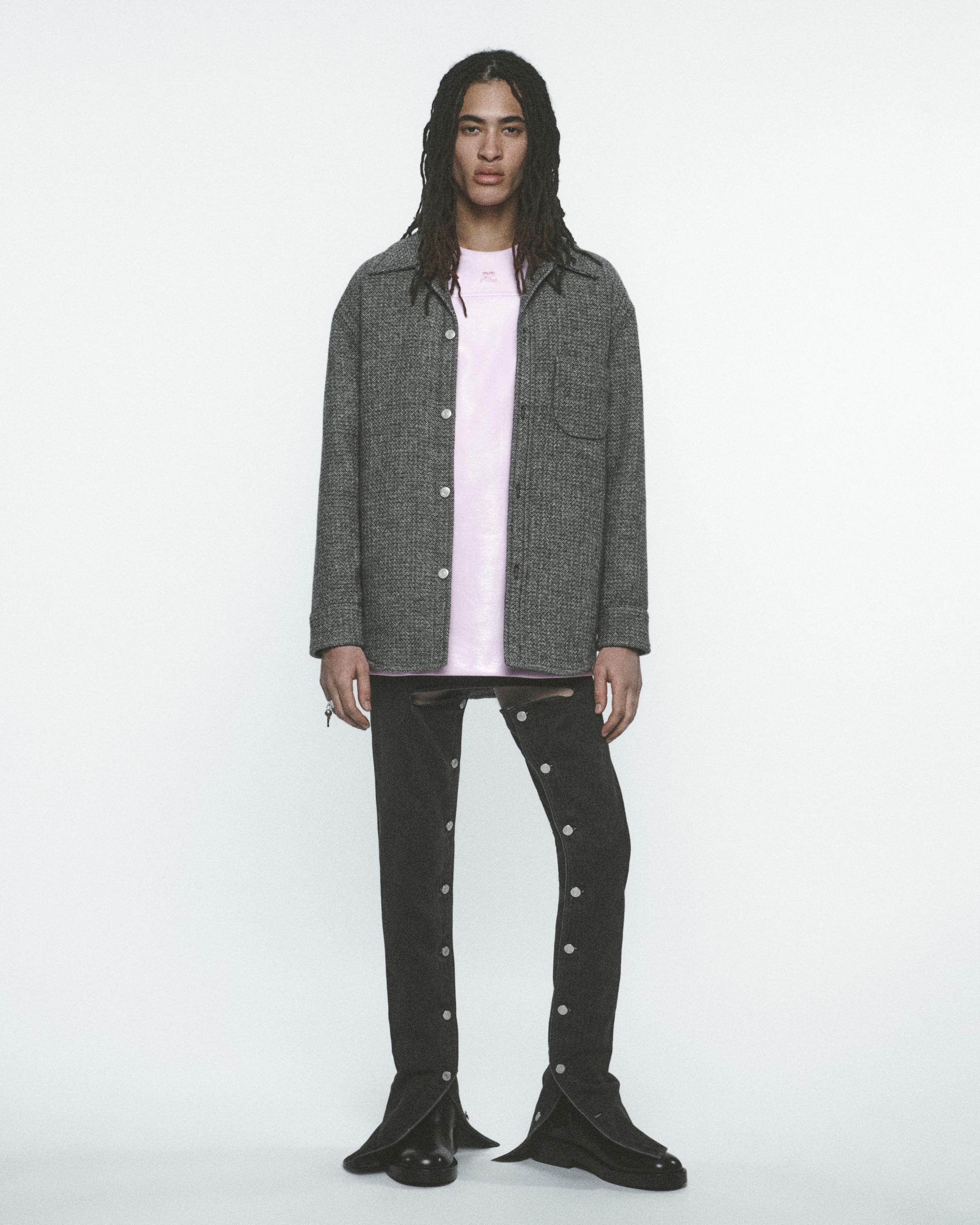 Fashion model wearing Courrèges grey jacket with pink t-shirt, stylish and modern look.