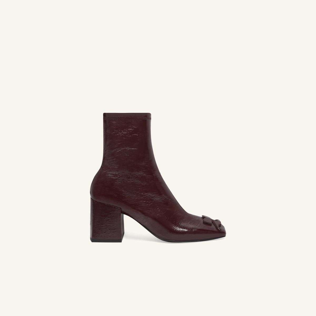 Elegant burgundy leather ankle boot with a square heel and bow detail, Courrèges fashion.