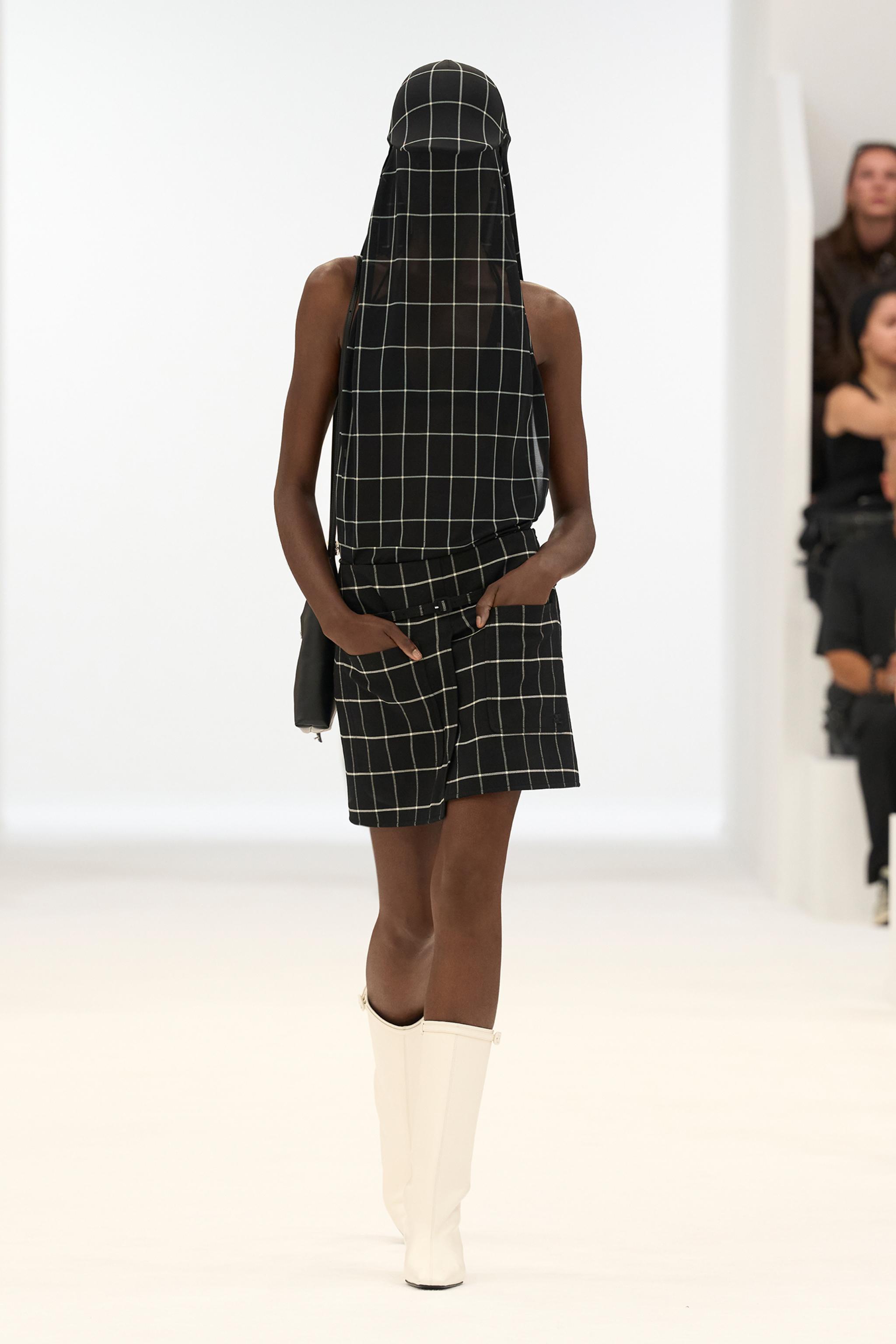 Elegant black and white checkered fashion ensemble from Courrèges on a runway display.
