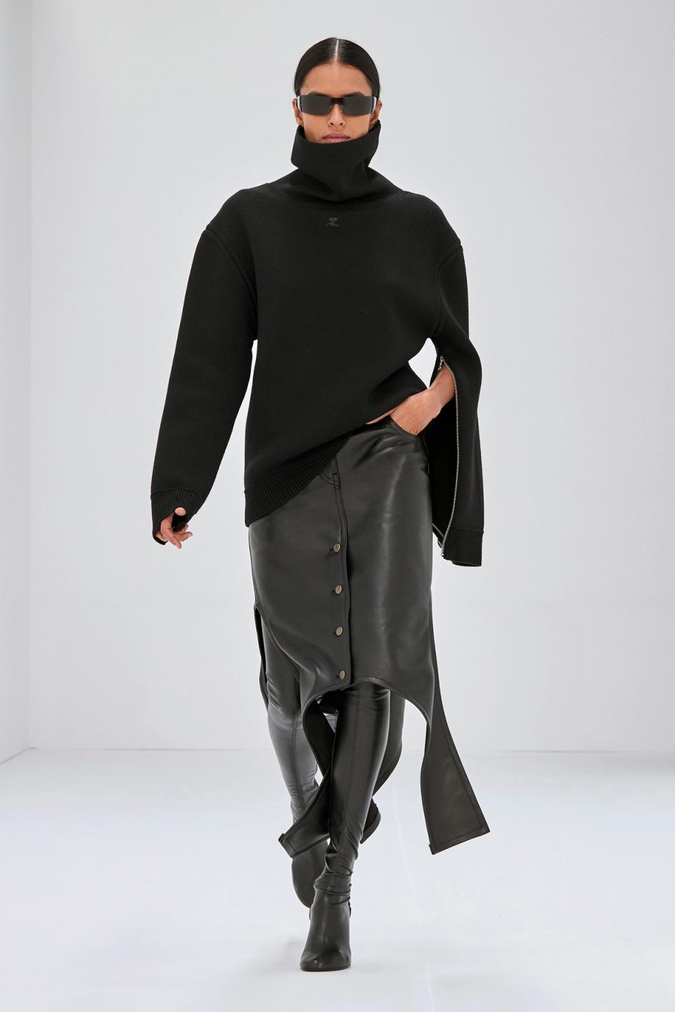 Elegant black fashion ensemble featuring a high-neck sweater, leather skirt, and over-the-knee boots, Courrèges style.
