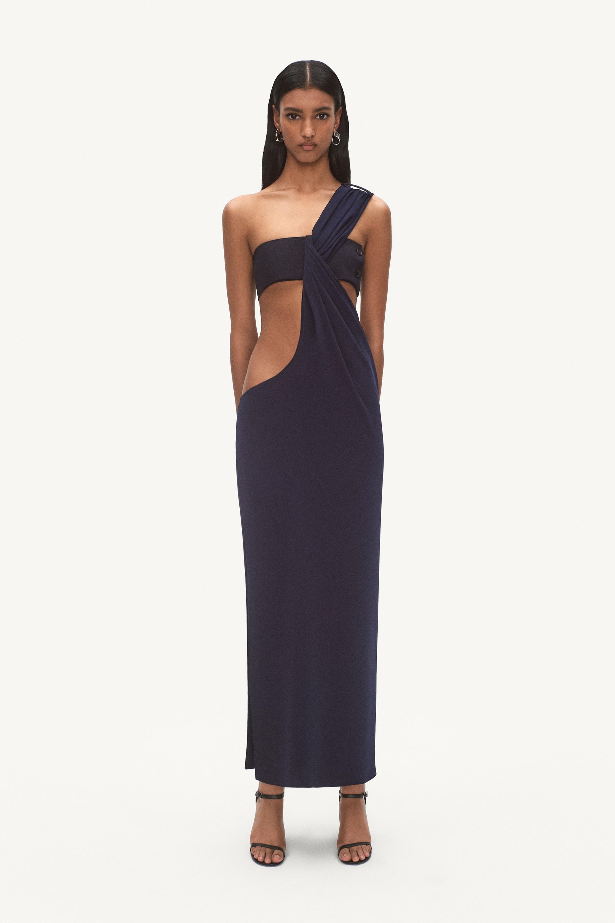 Elegant navy cut-out dress by Courrèges on a fashion model for an ecommerce website.