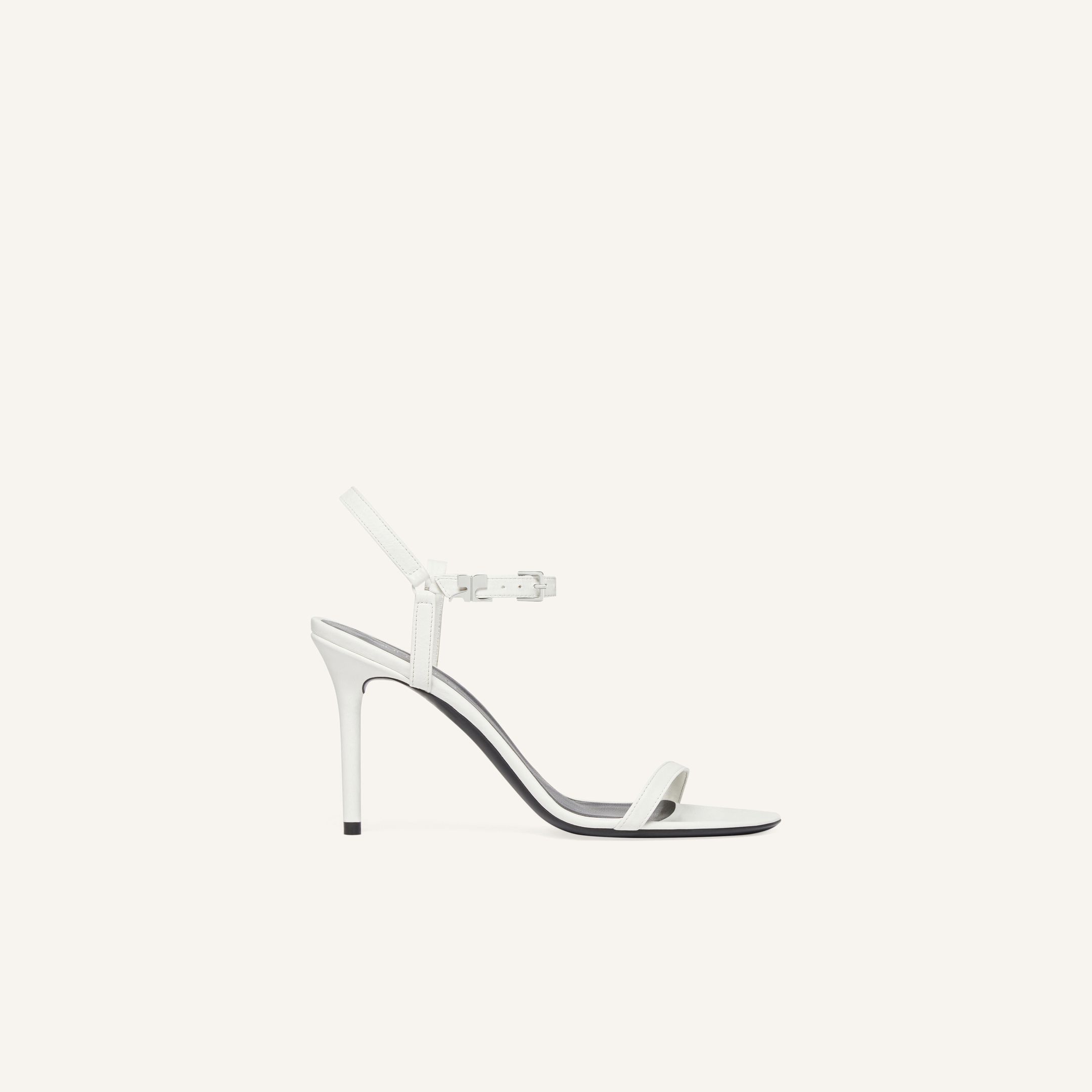 Sandale blanche à talon haut élégante de Courrèges, symbole de style pour la mode.