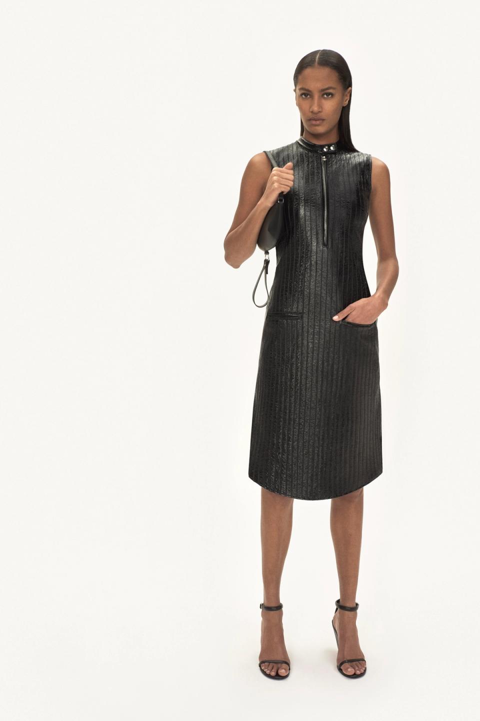 Elegant black leather dress with a high collar, zip front, and sleek straight silhouette for Courrèges.