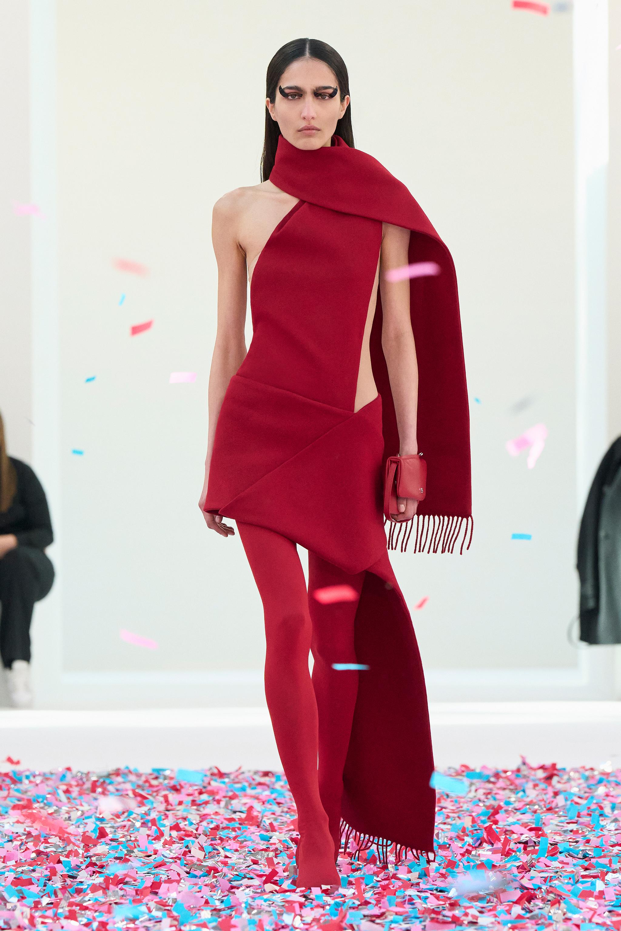 Elegant red dress with a unique cut, showcasing Courrèges's futuristic fashion style.