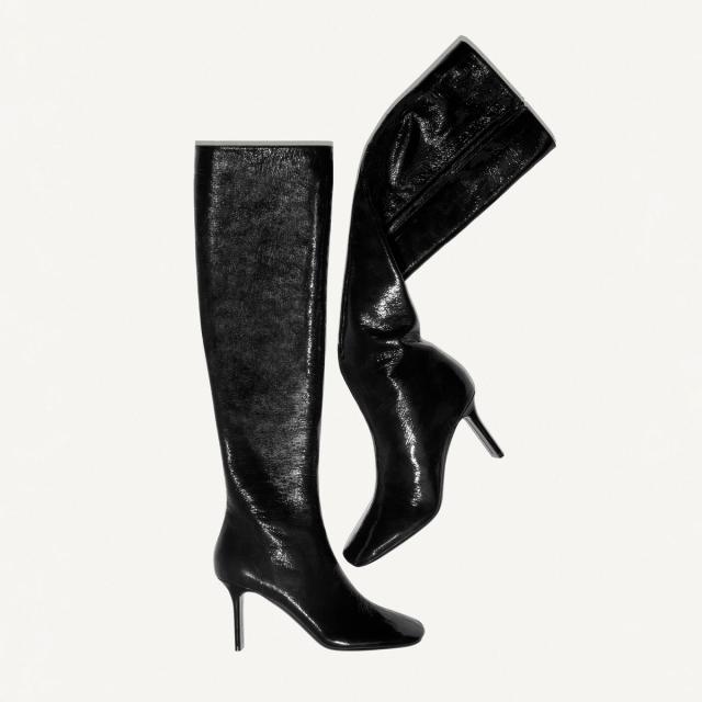 Elegant black knee-high leather boots with stiletto heels, by Courrèges, perfect for fashion enthusiasts.