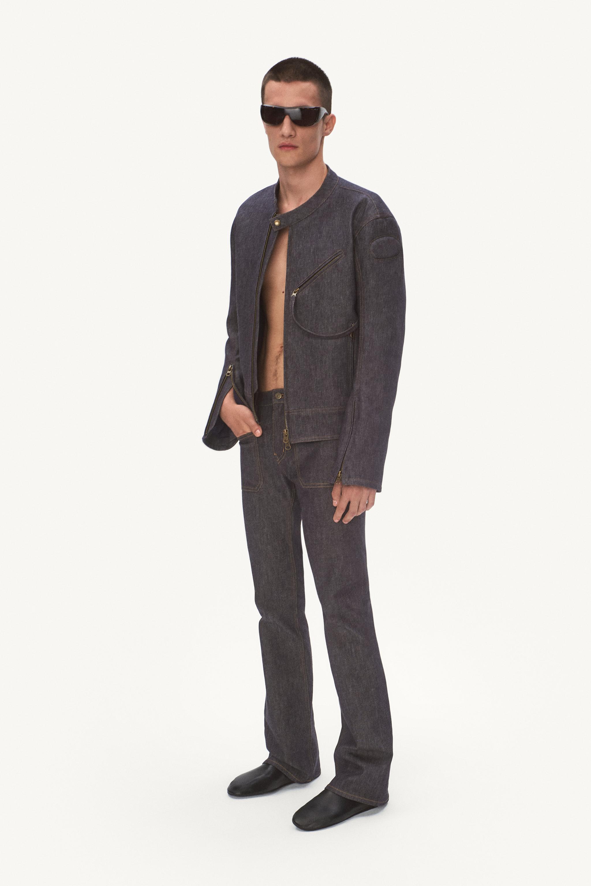 Elegant denim outfit by Courrèges featuring a stylish jacket, matching jeans, and futuristic sunglasses.