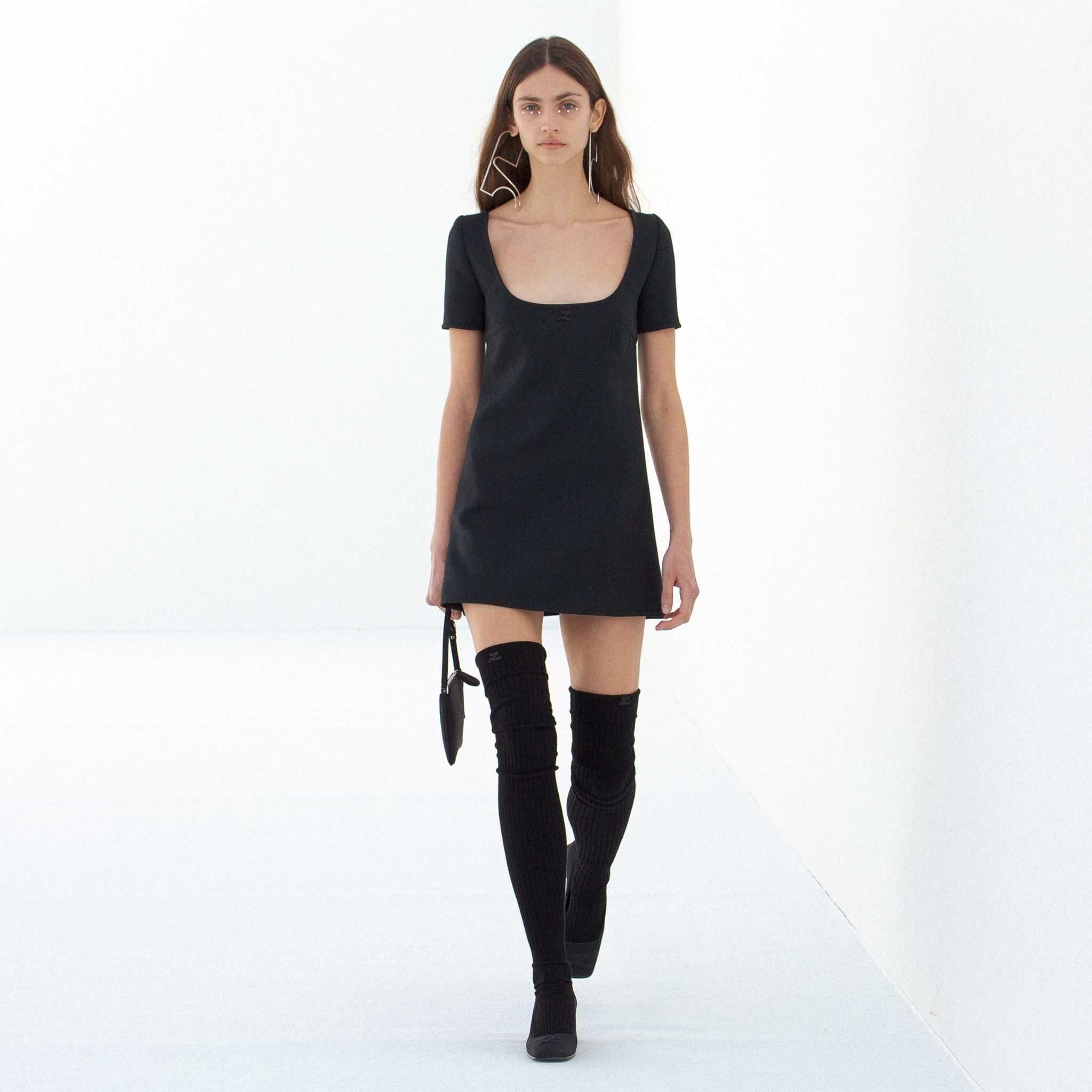 Elegant black dress with a square neckline, showcasing Courrèges style on an ecommerce site.