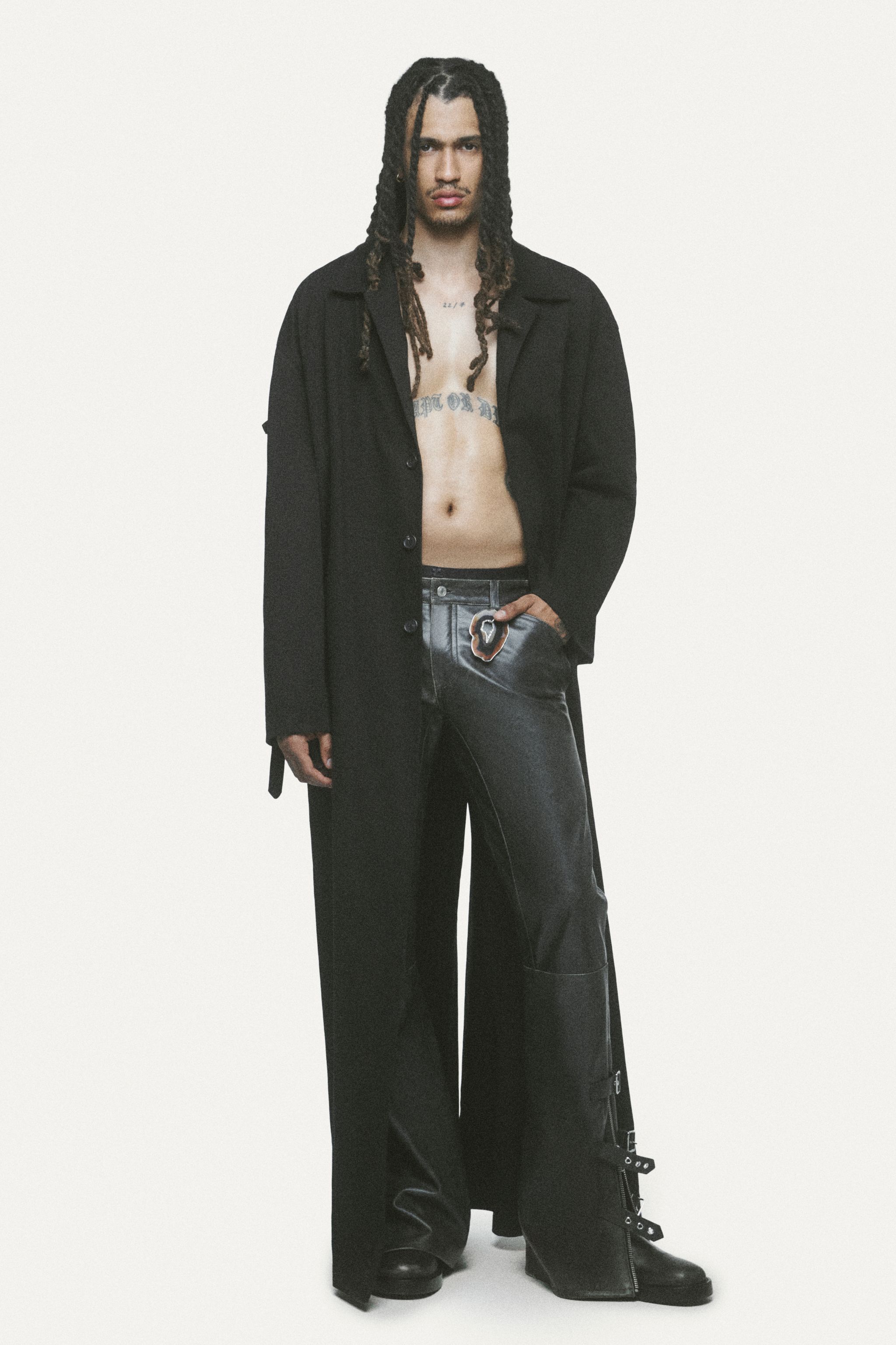 Elegant, modern black Courrèges outfit featuring a sleeveless dress, oversized hoodie, and accessories.
