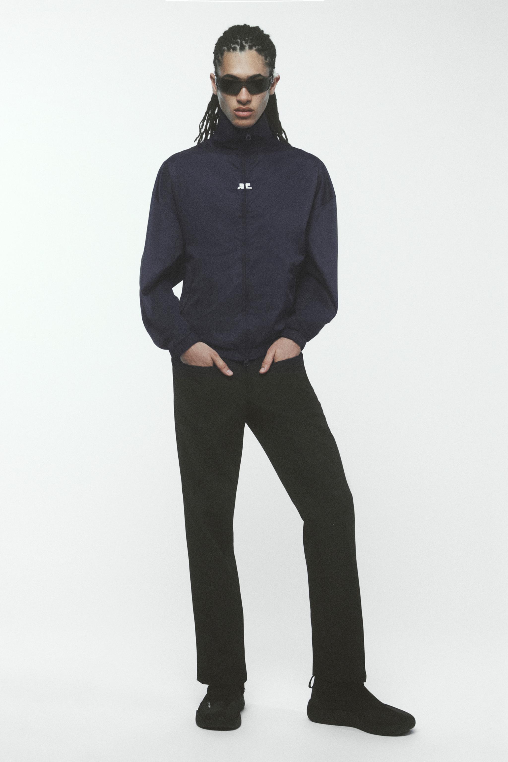Elegant black Courrèges jacket paired with black pants, stylish and perfect for fashion shopping.