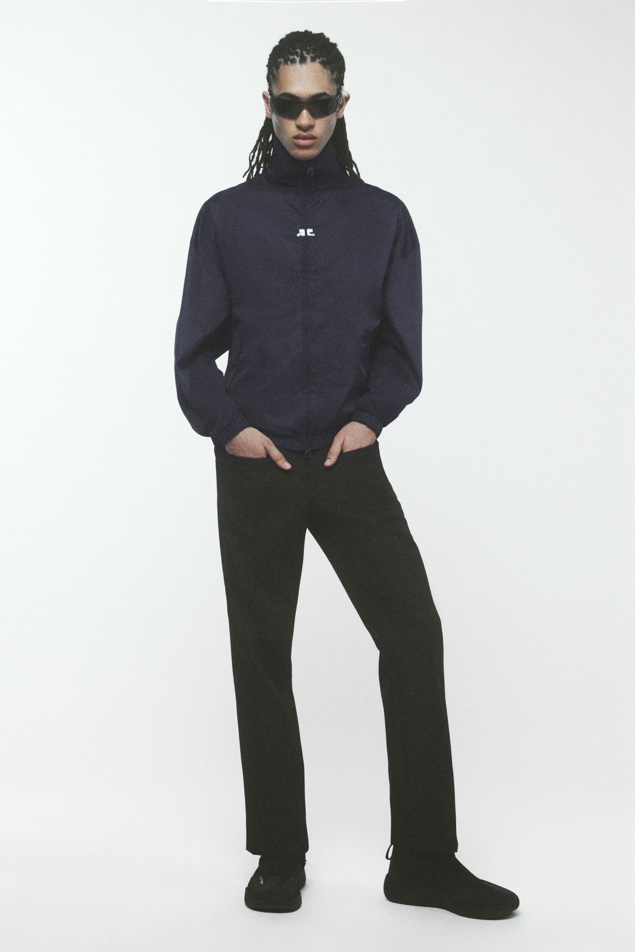 Elegant black Courrèges jacket paired with black pants, stylish and perfect for fashion shopping.