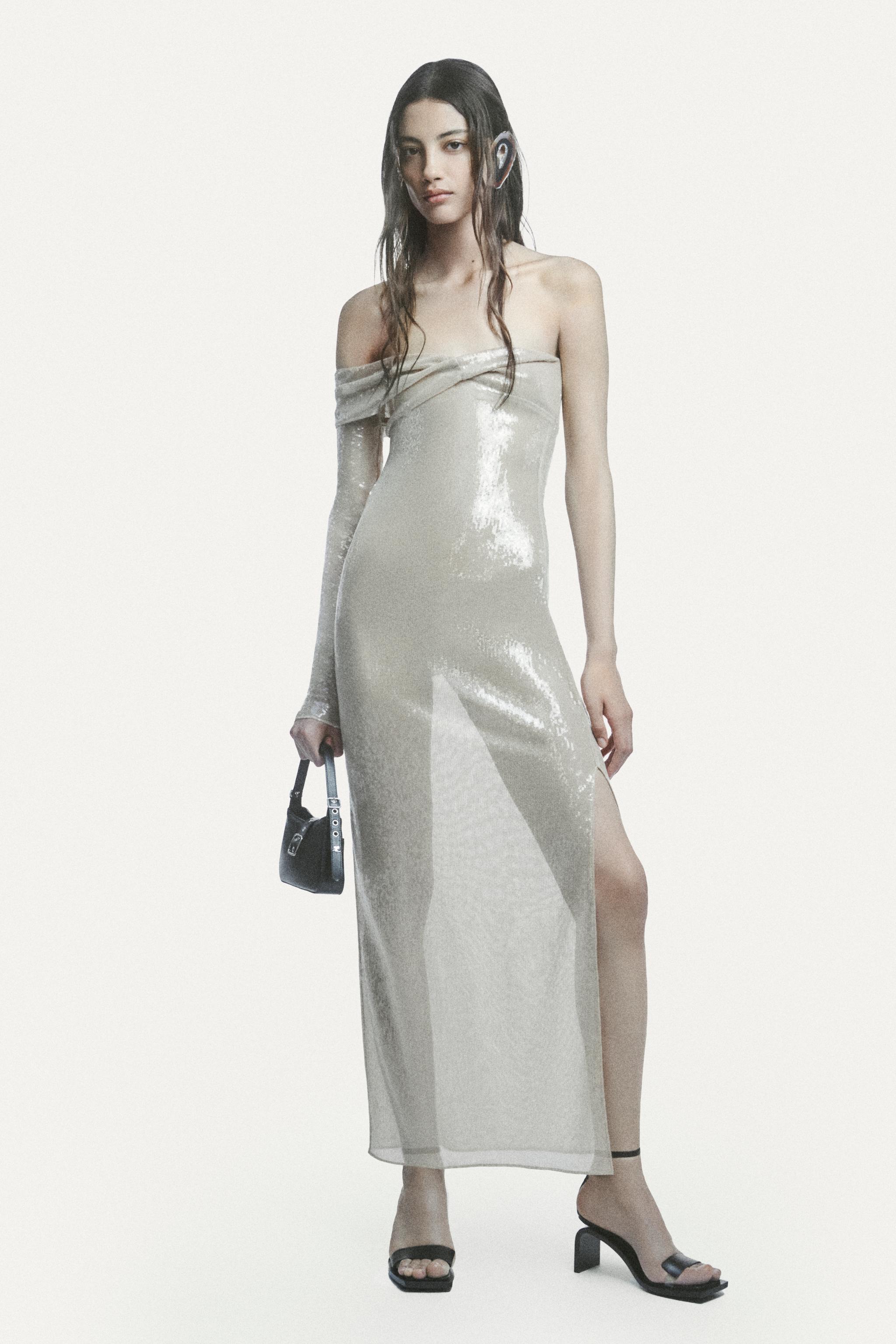 Elegant model in a sleek, shiny gown with a modern, fashion-forward look for Courrèges.