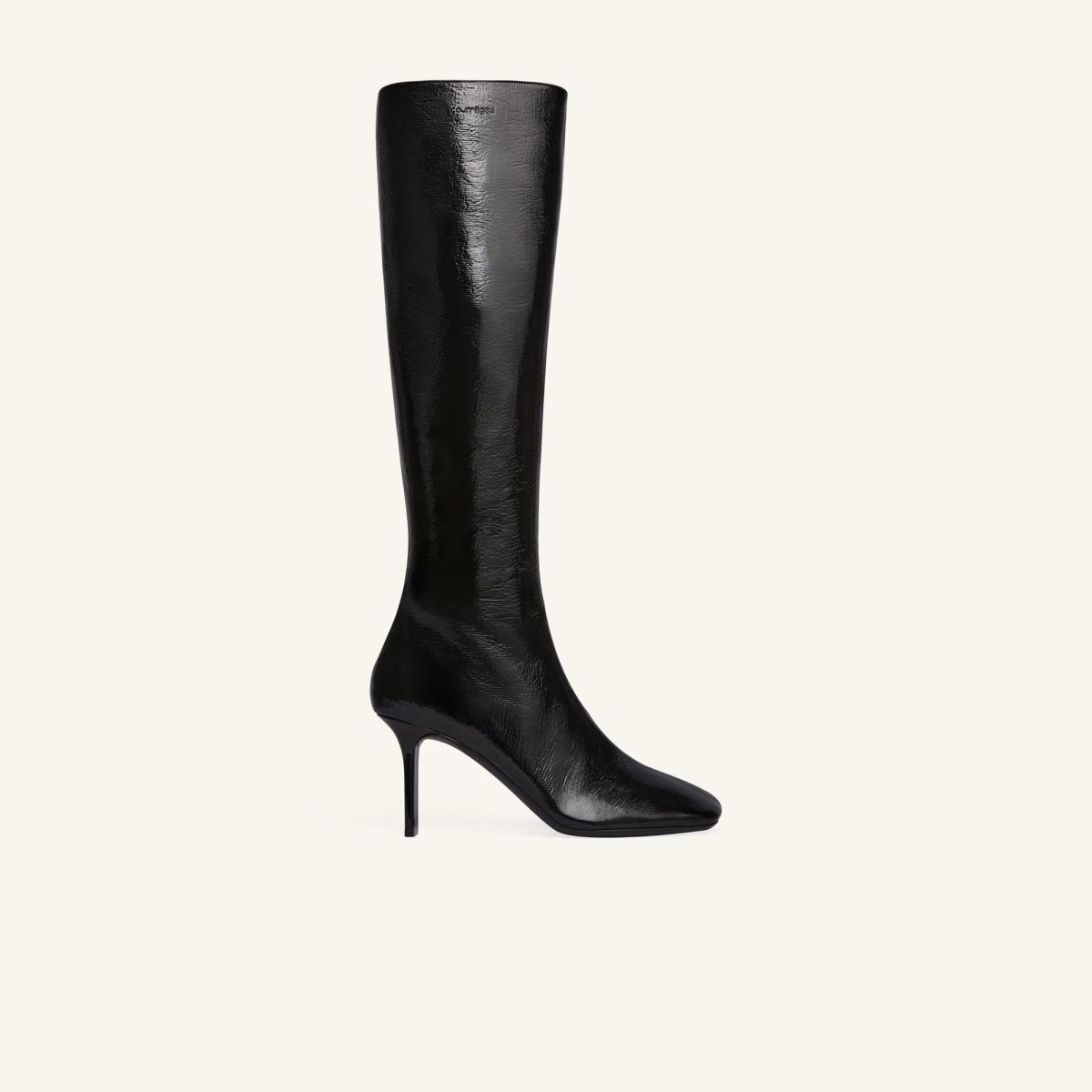 Elegant black knee-high leather boot with a sleek pointed toe for Courrèges fashion collection.