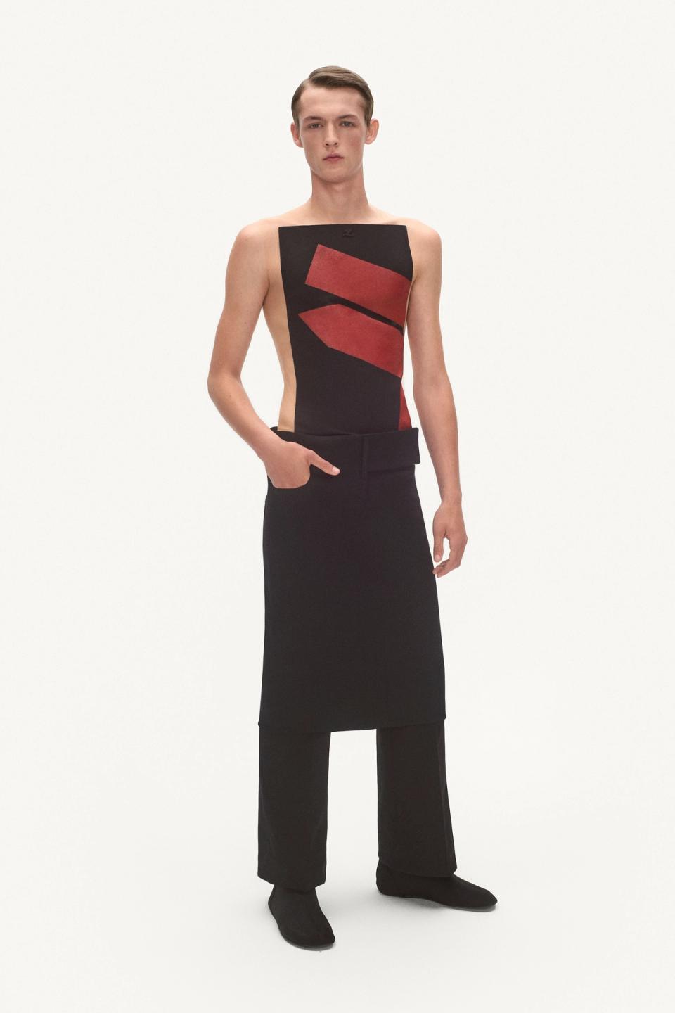 Elegant male model wearing a stylish black and red design dress from Courrèges, suitable for fashion lovers.