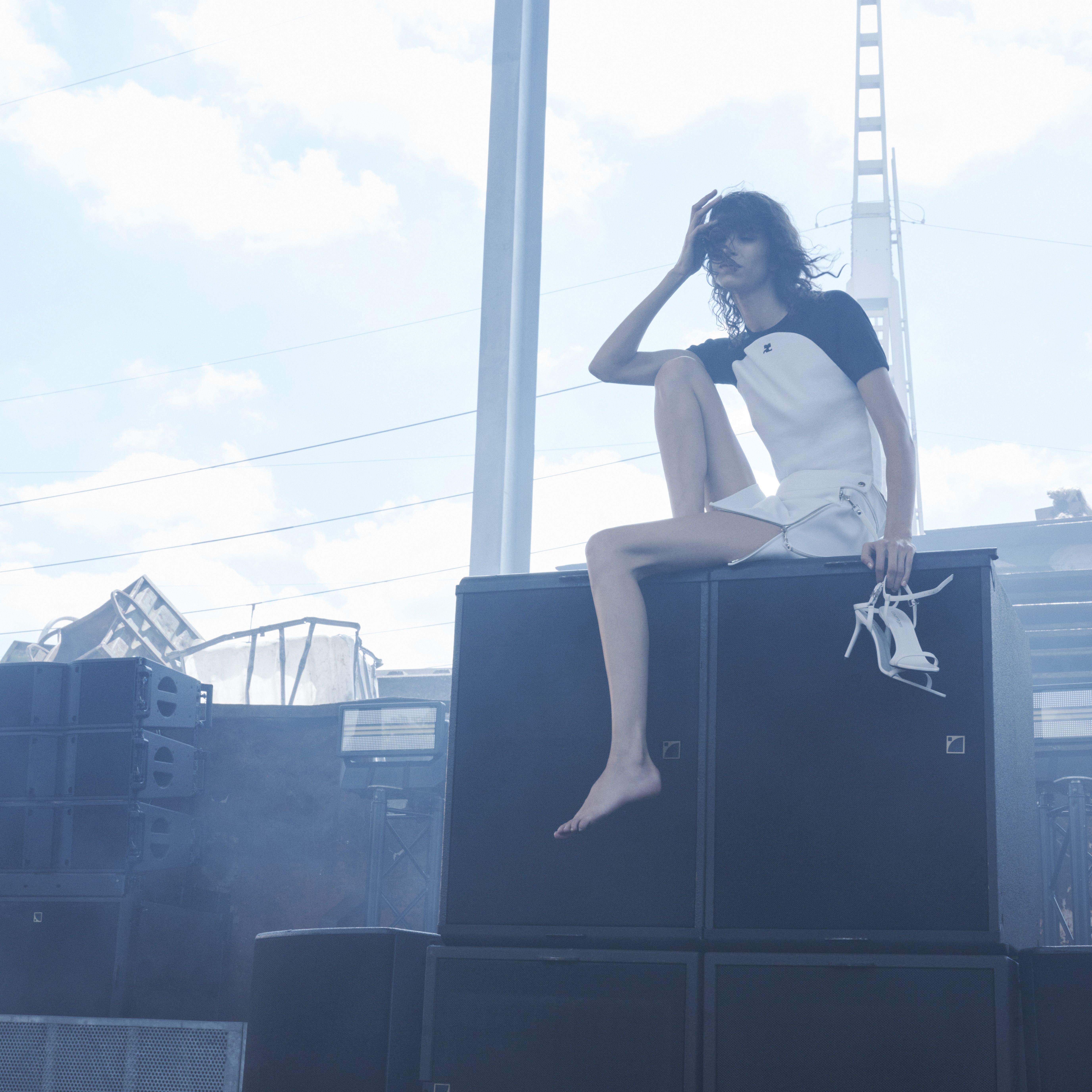 Elegant Courrèges fashion ensemble featuring a stylish white and black outfit, showcased outdoors.