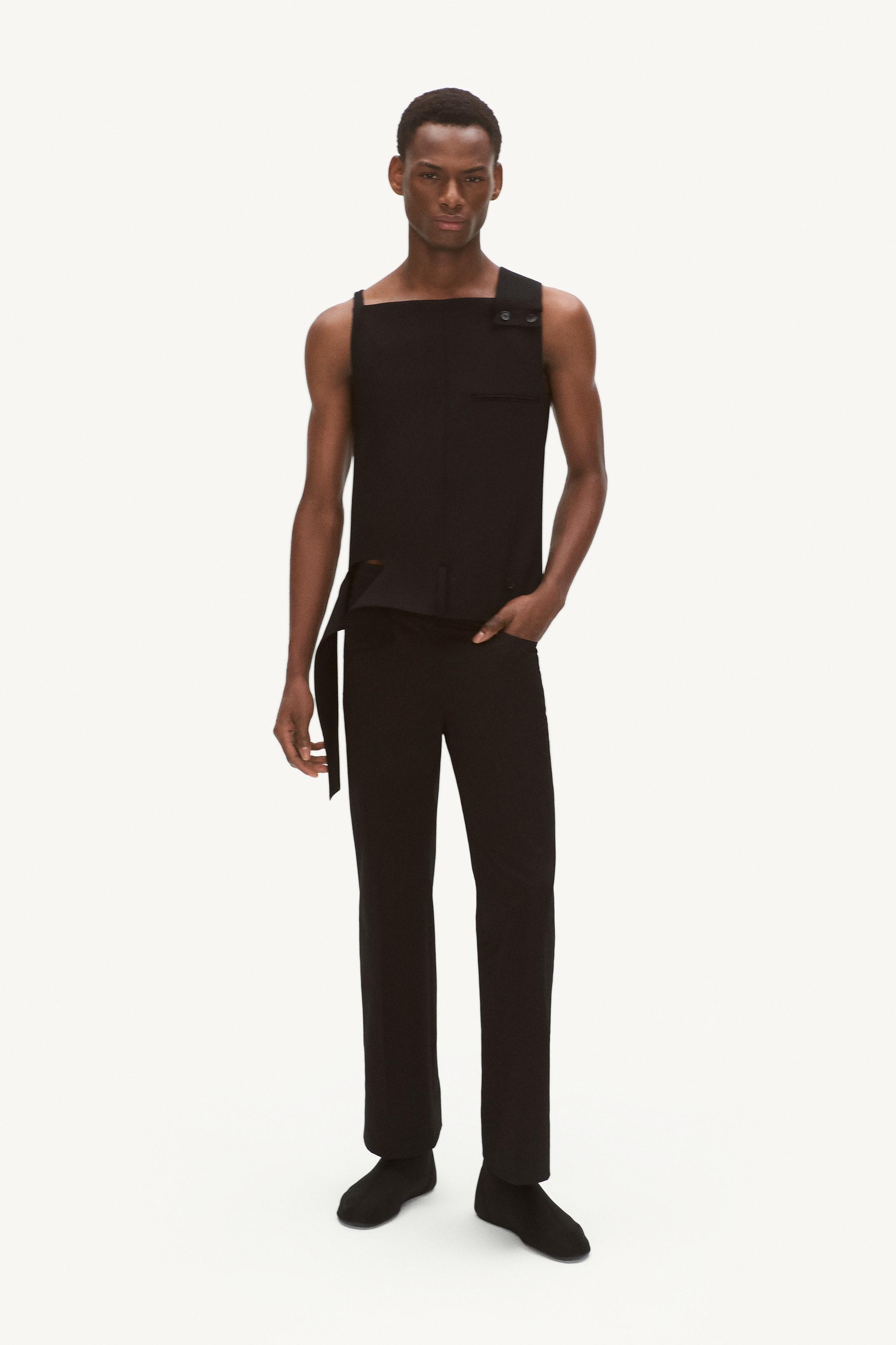 Elegant black sleeveless top by Courrèges showcased on a fashion model for ecommerce.